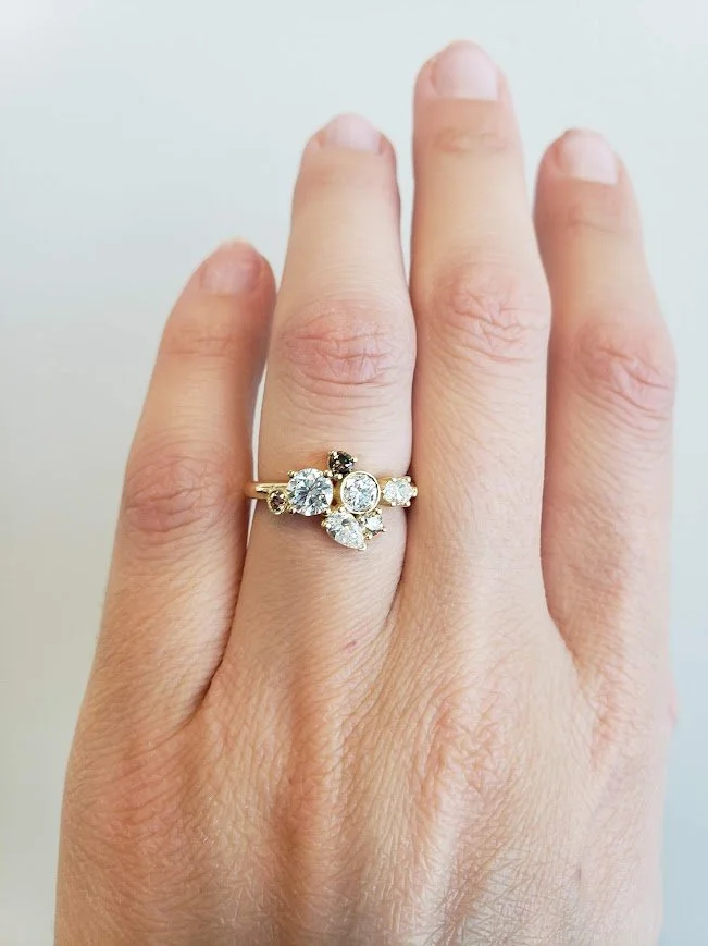 Custom redesign using client's existing stones in yellow gold, set into a mixture of bezel and prong settings