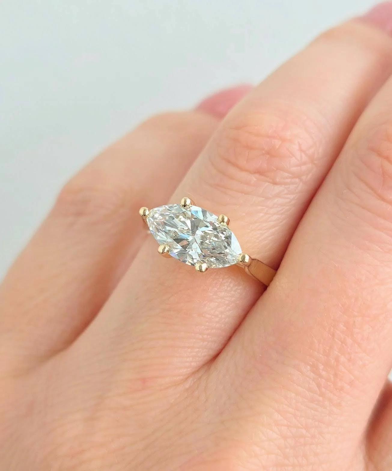 Custom East-West marquise diamond engagement ring in 14K yellow gold