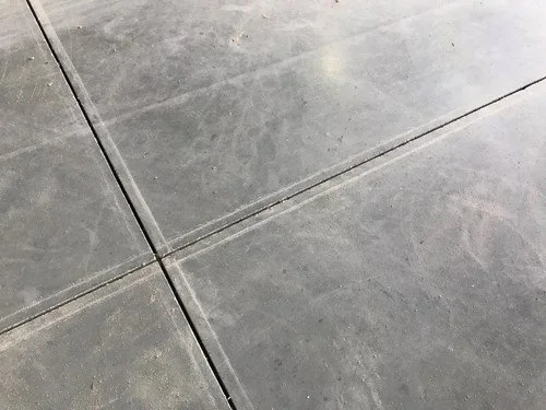 Close-up image of gray concrete floor tiles with visible grout lines.