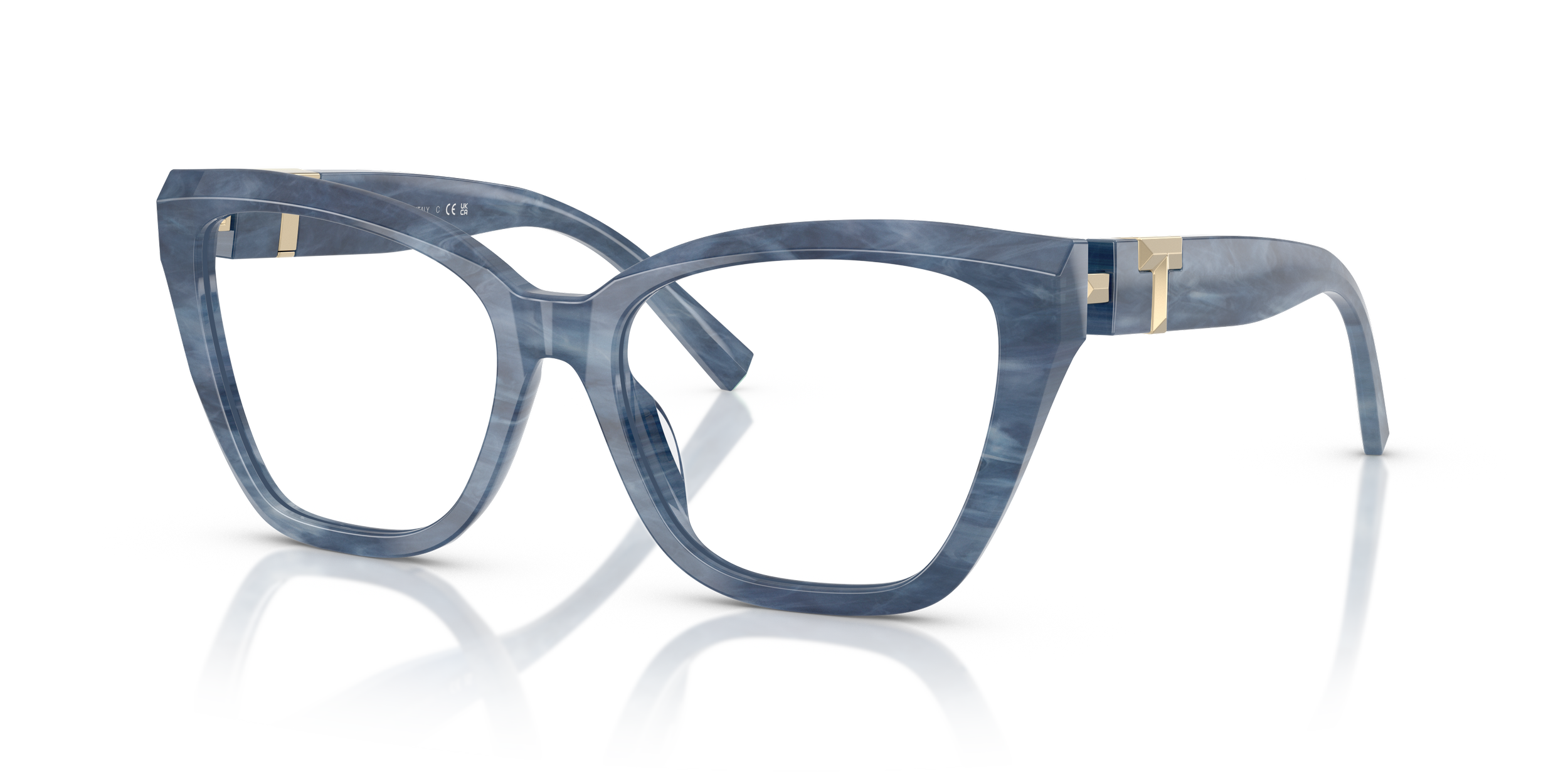 A pair of fashionable Tiffany designer eyeglasses with a marbled blue frame and clear lenses, resting on a reflective surface.