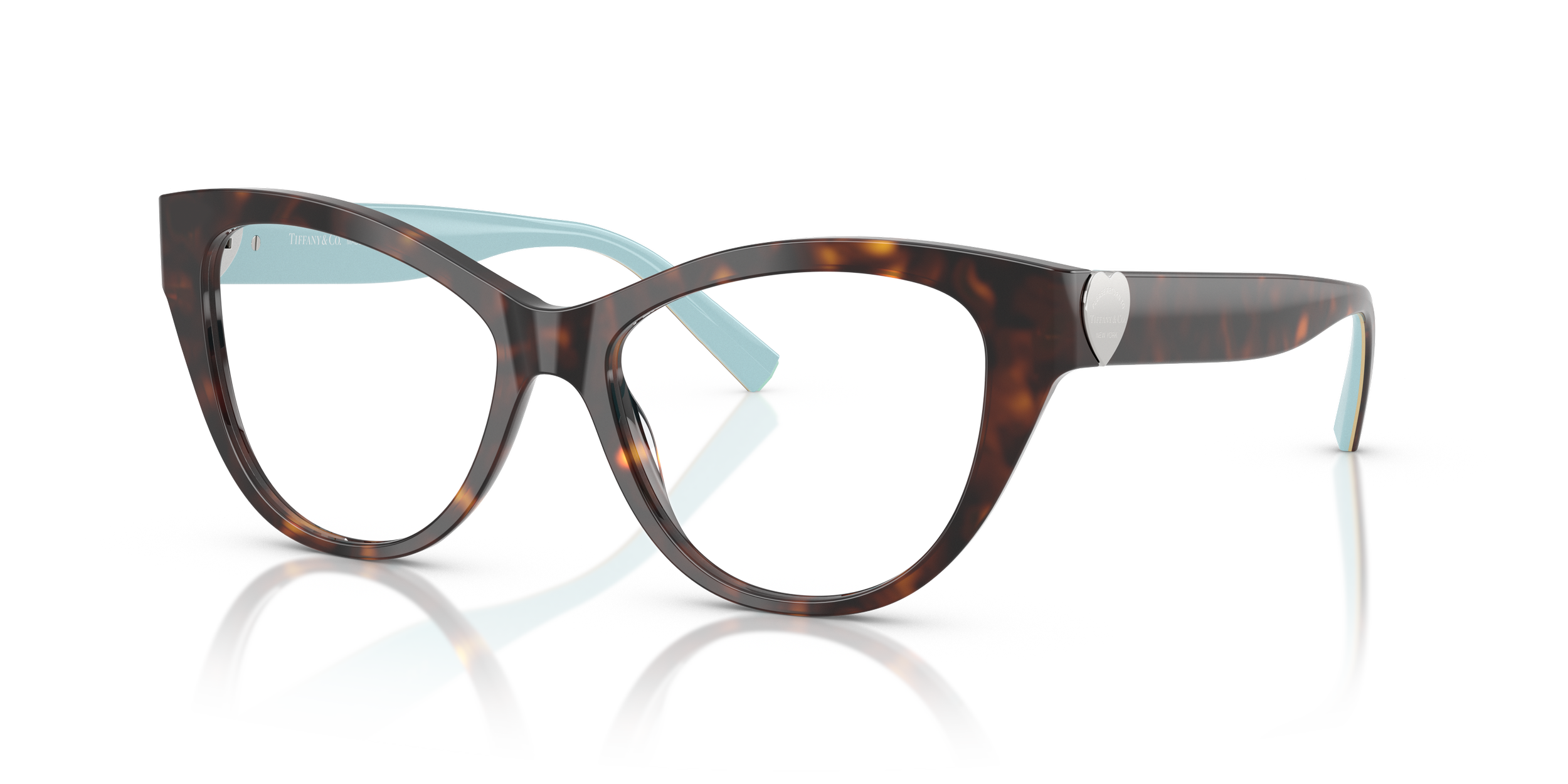A pair of Tiffany designer eyeglasses with tortoiseshell frames and light blue temple tips, positioned on a reflective white surface.