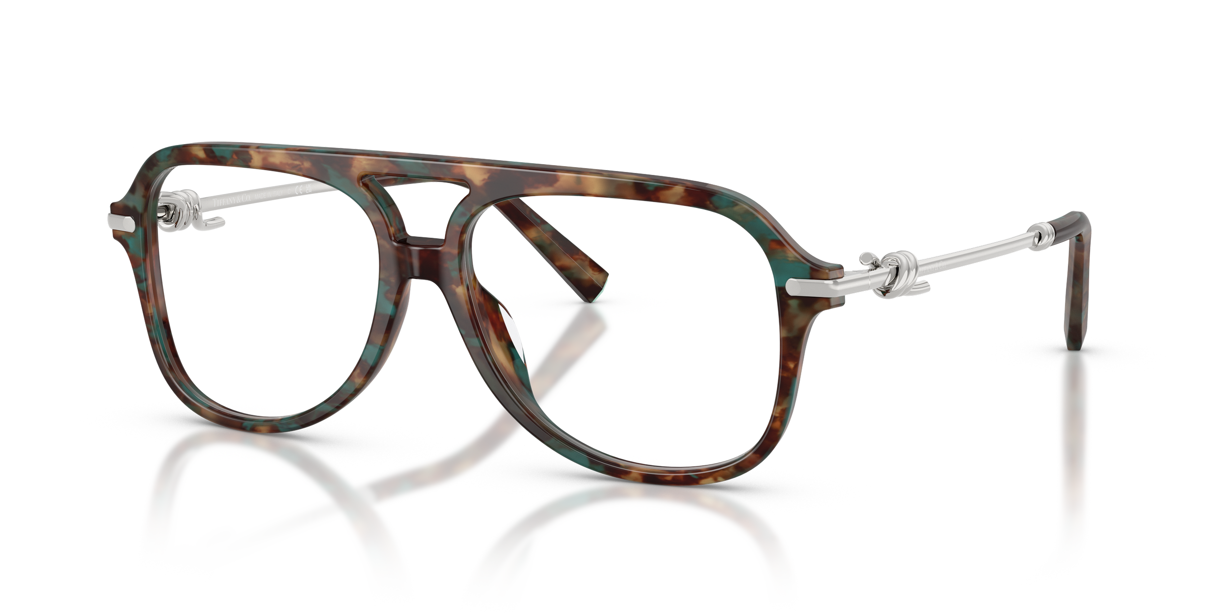 Pair of fashionable Tiffany designer eyeglasses with tortoiseshell frames and silver metallic arms, reflection visible on surface.