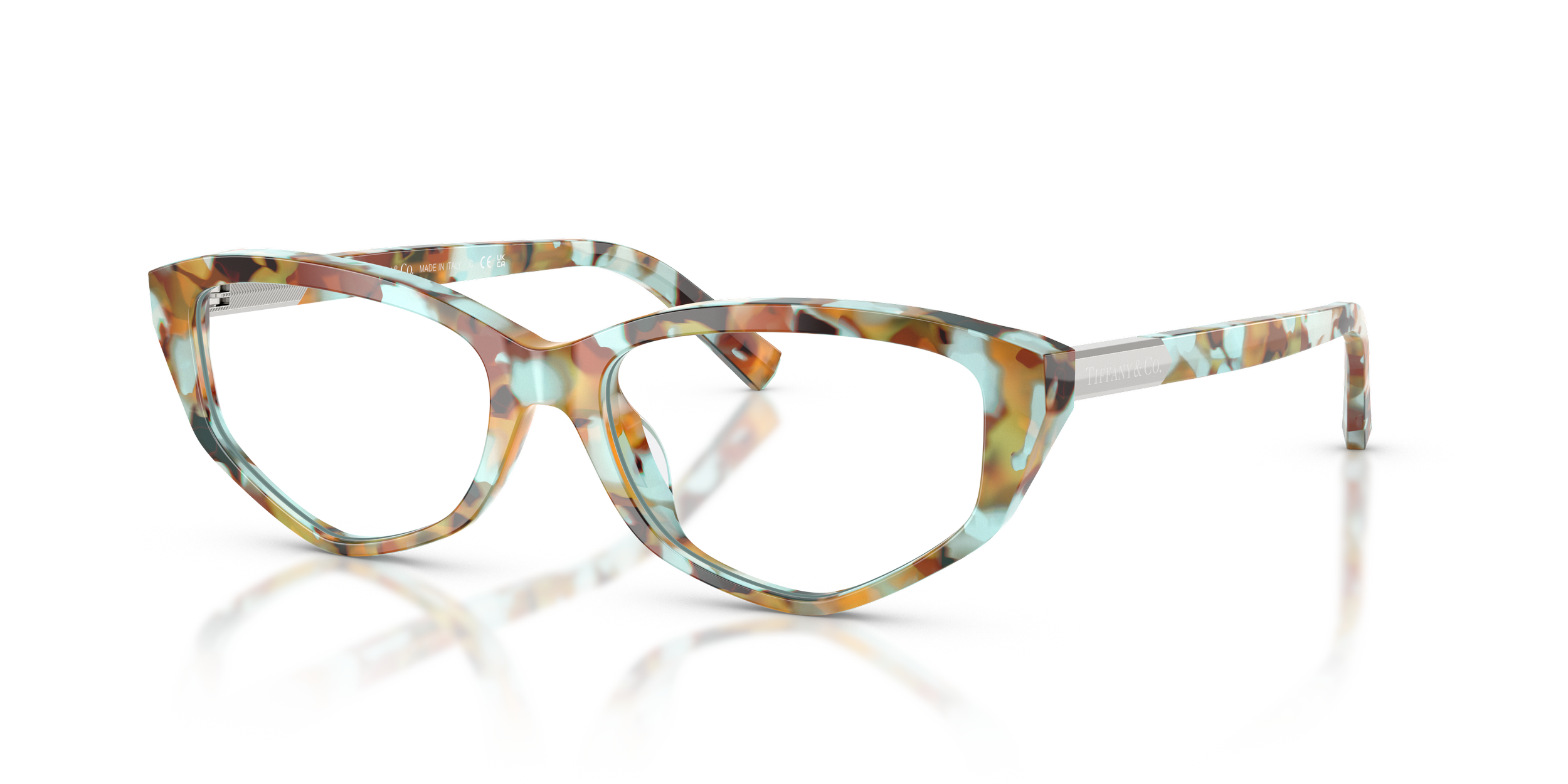Colorful, tortoiseshell-patterned Tiffany designer eyeglasses with clear lenses, placed on a reflective surface against a white background.