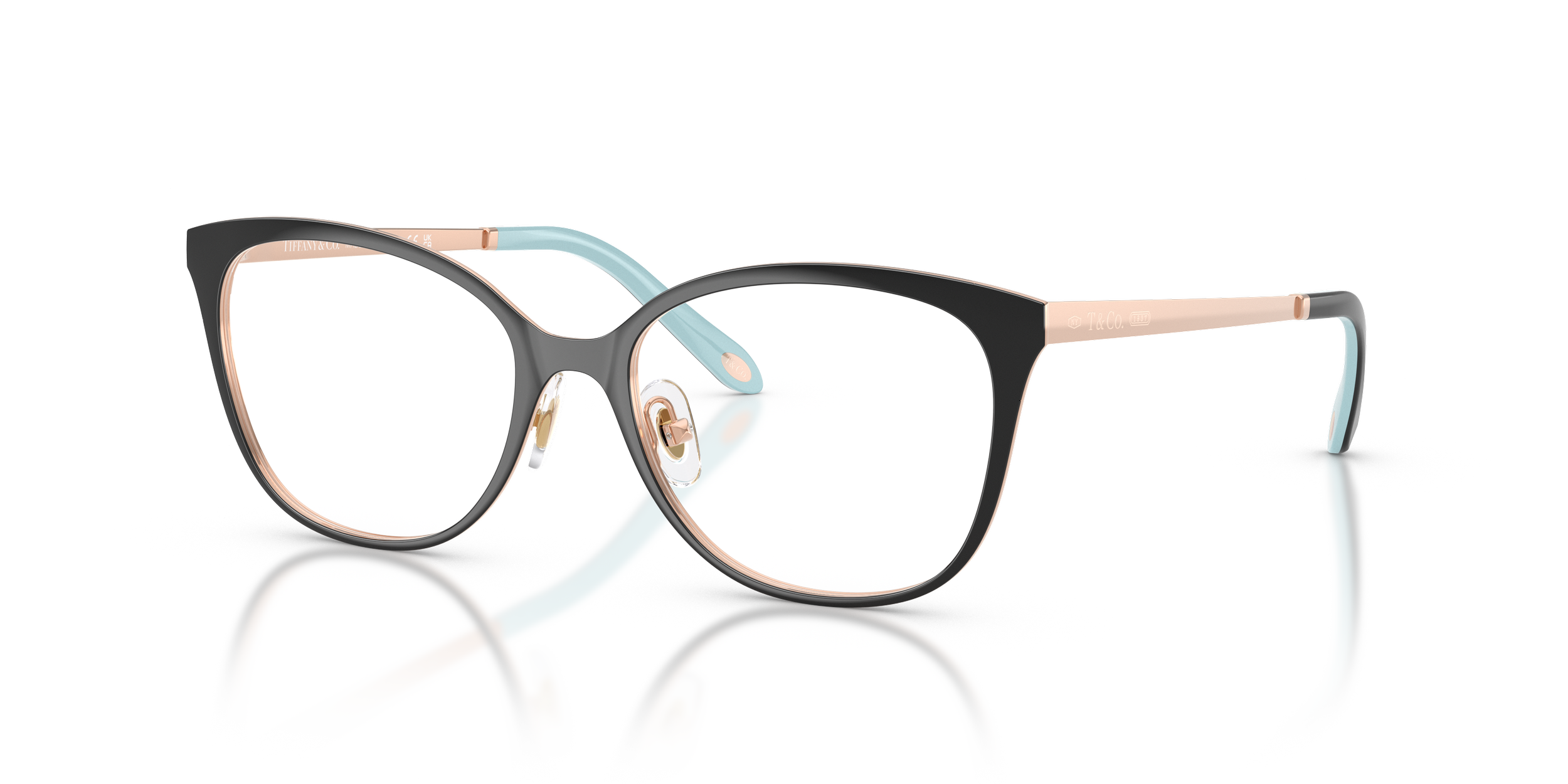 A pair of fashionable Tiffany & Co. eyeglasses with black frames, rose gold accents, and light blue temples, reflected on a white surface.