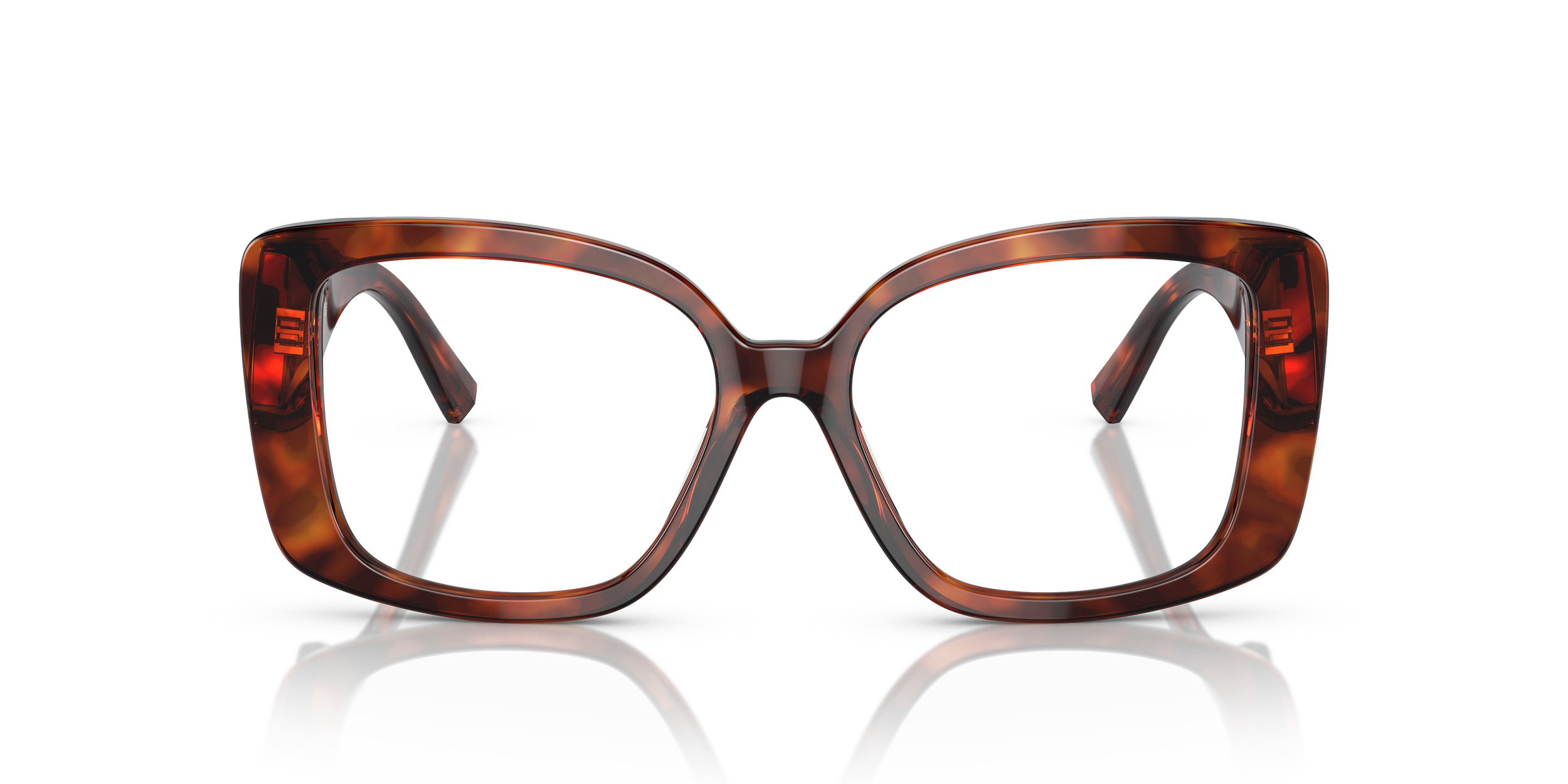 Close-up of Tiffany tortoiseshell eyeglasses with clear lenses, reflected on a glossy surface against a white background.