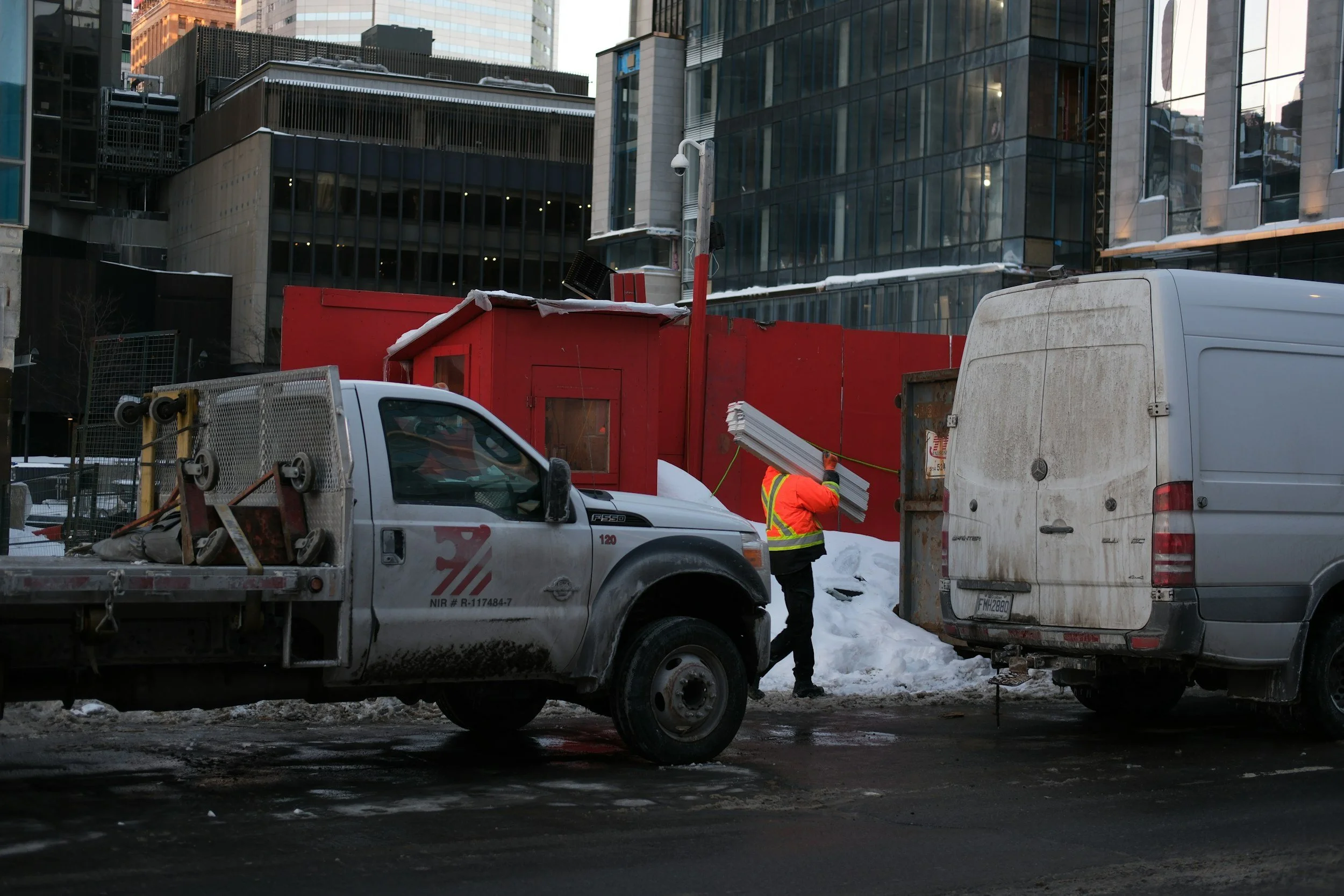 Worker wearing insulated waterproof Tiger King work boots in winter construction site - slip-resistant boots for cold-weather safety.