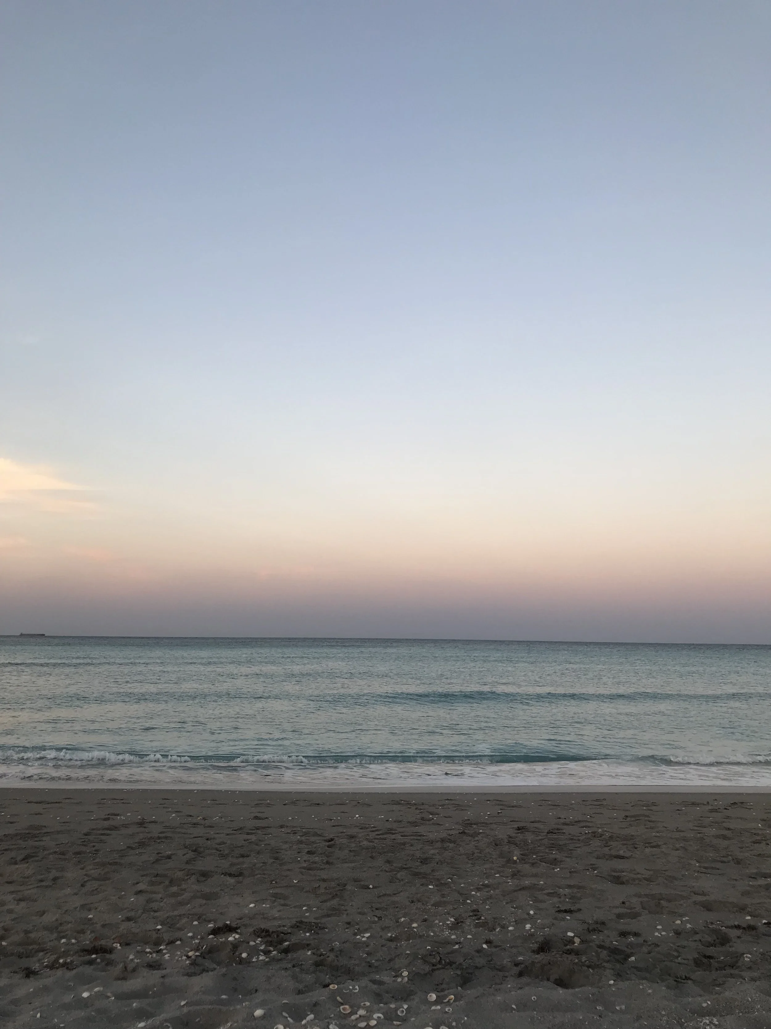 Photo of a calm ocean shore at sunset in Juno Beach, FL