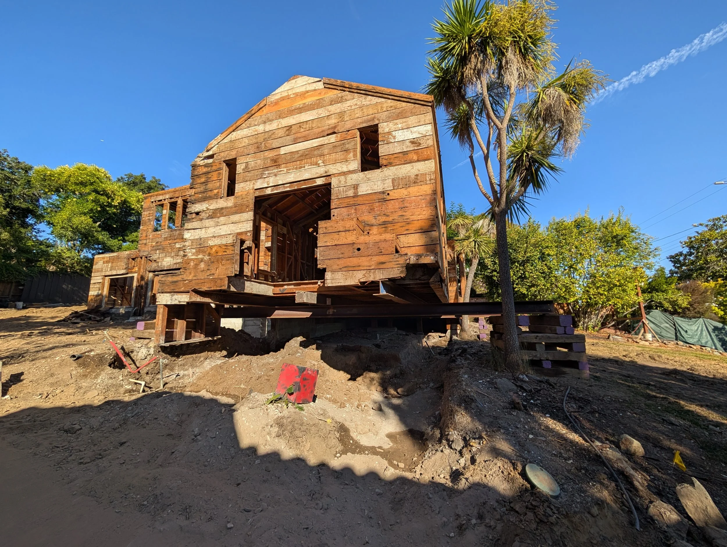Early stages of transformation: this home was carefully lifted in place so we could excavate a new garage and pour a completely new foundation underneath. A rare process that highlights both the engineering challenges and the exciting possibilities o