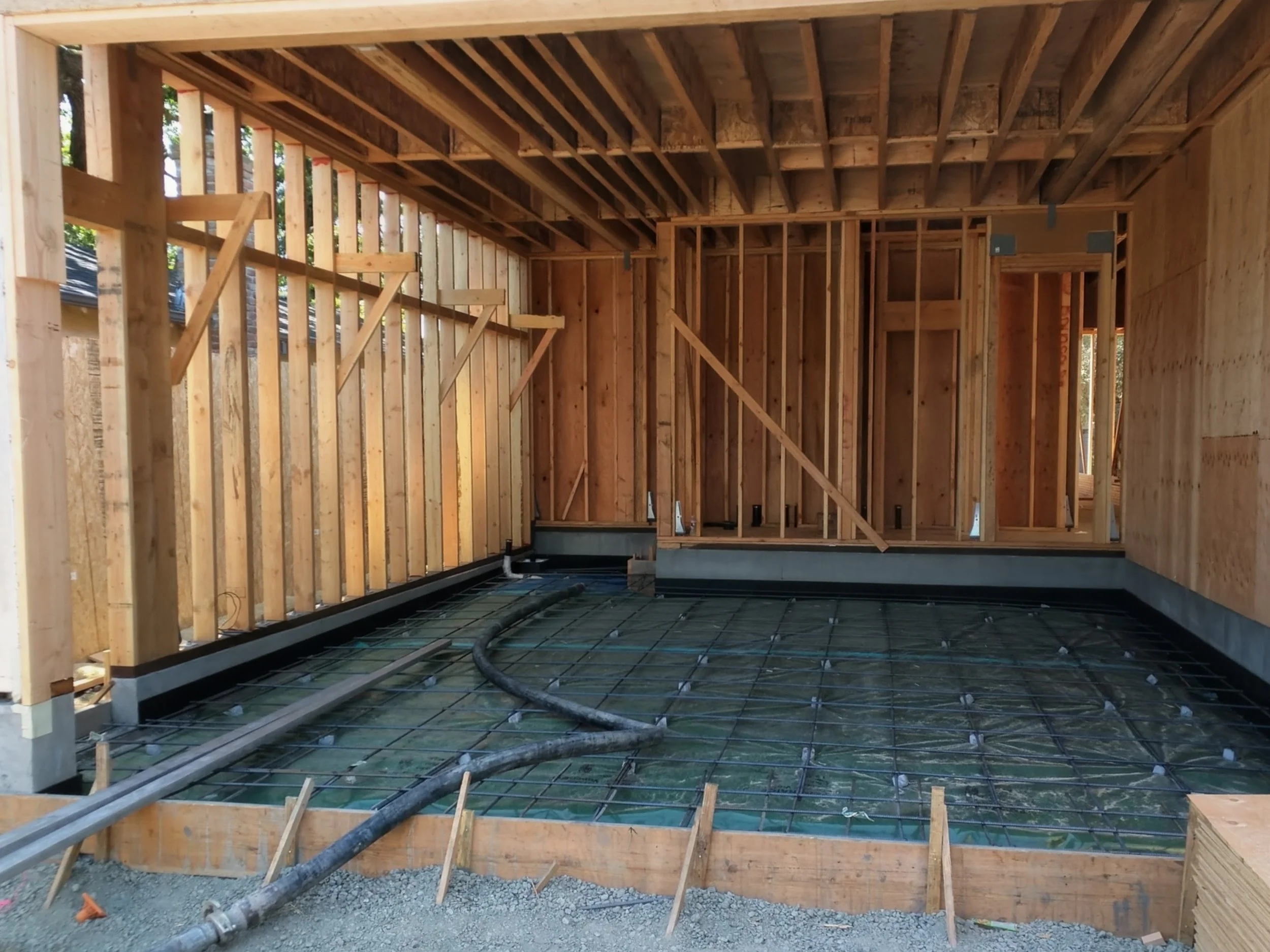 Garage foundation prep: rebar and framing in place, ready for concrete pour and structural strength.