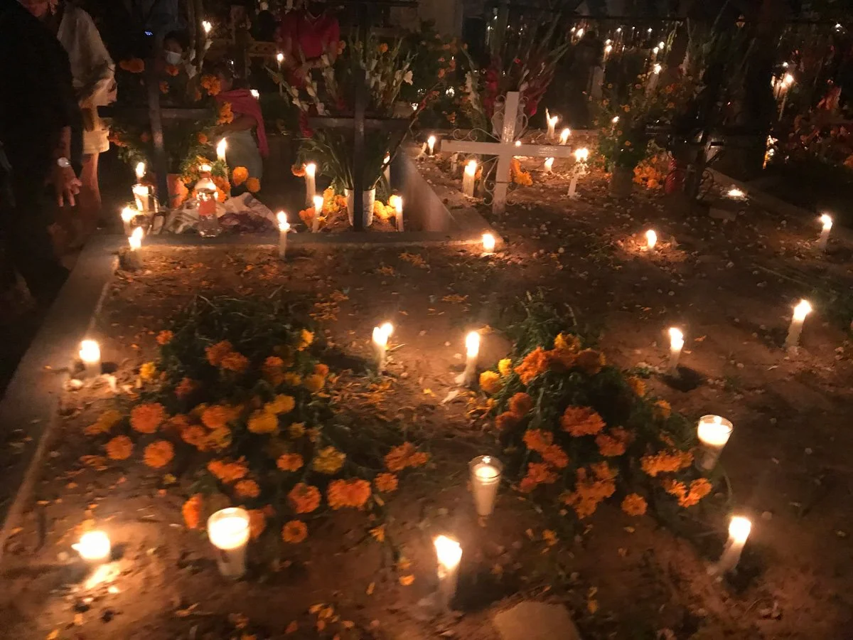 Candles on graves on dia de los muertos in mexico