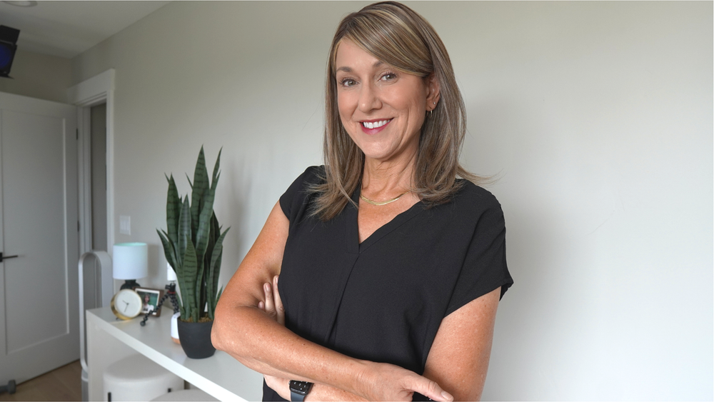 Shelley Perry, arms crossed, smiling