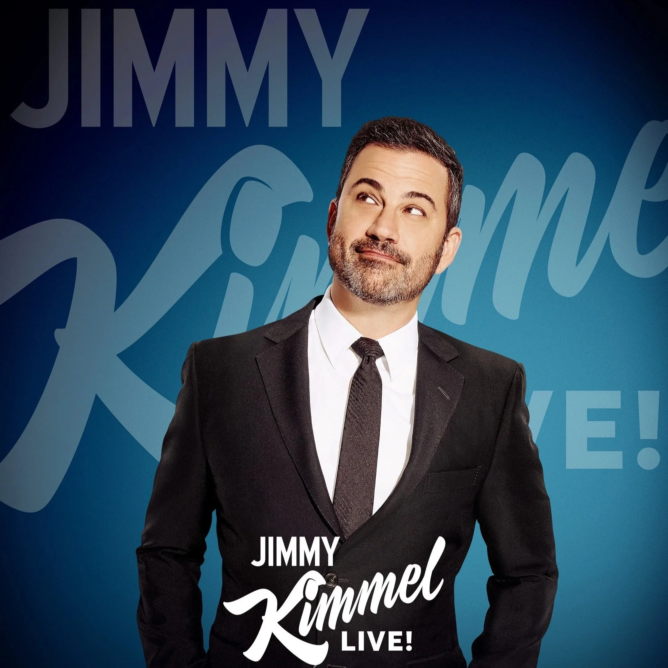 Photograph of Jimmy Kimmel wearing a black suit, white shirt, and black tie, standing in front of a blue background with overlapping text that says "Jimmy Kimmel LIVE!" in white and light blue letters.