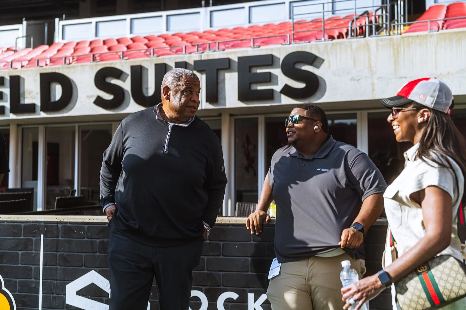 Richard Bailey with colleagues at a football stadium