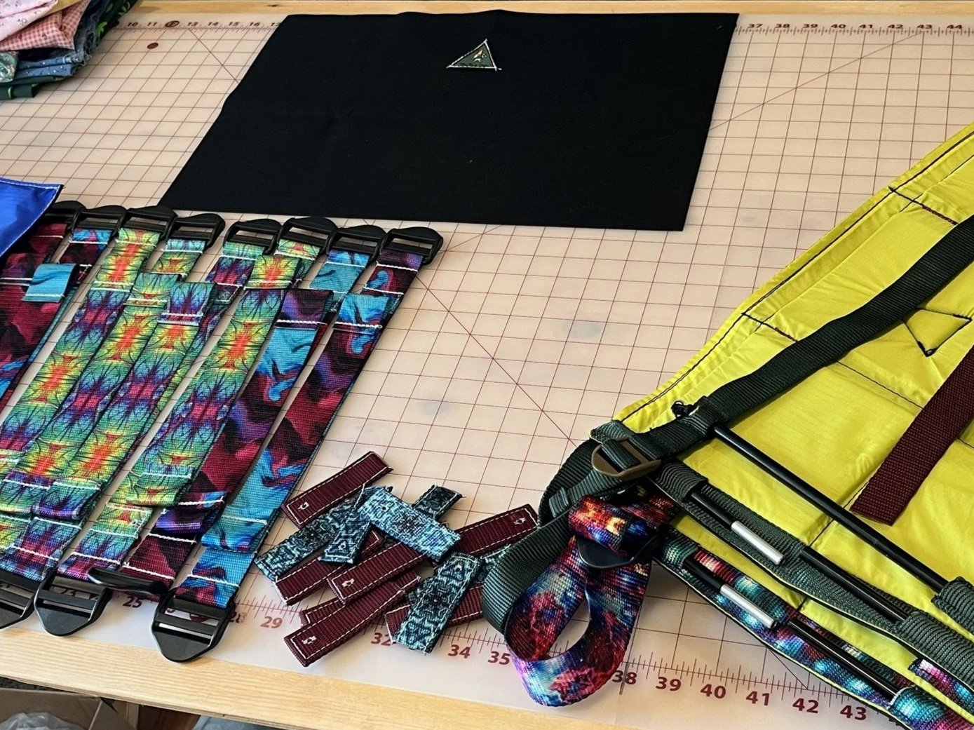 A green triangular embroidered patch with a black border, featuring a gnome carrying a backpack and wearing a bright orange hat, with the text "The Ped Chat" embroidered at the bottom.