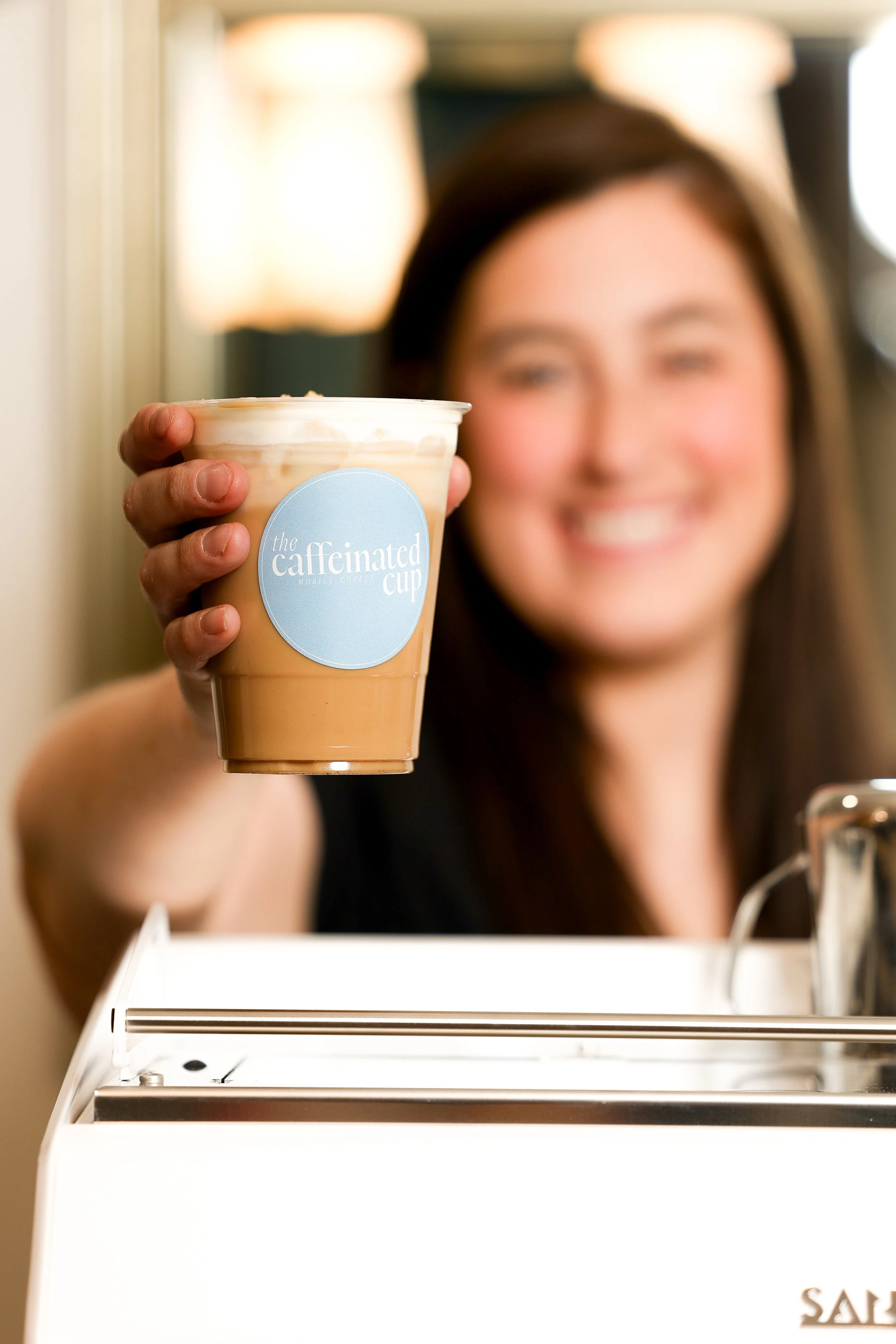 The owner serving a specialty latte at a South Jersey catered event.