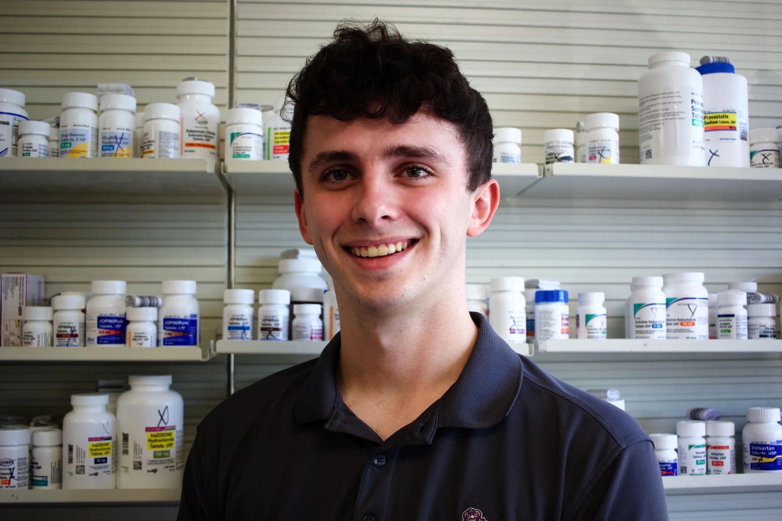 Black and white close-up of a rose with detailed petals and leaves.