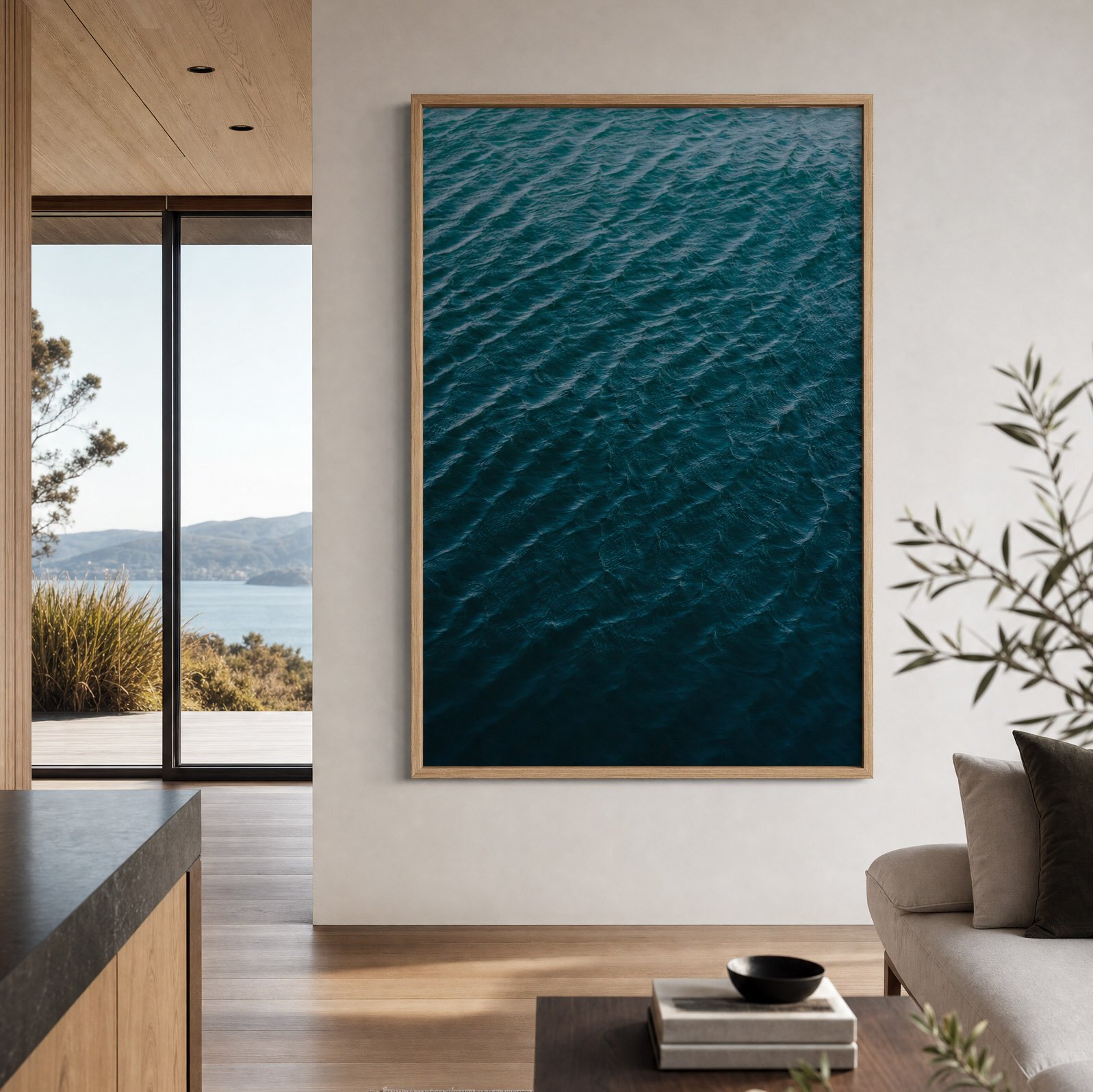Framed Adrift fine art print featuring deep blue ocean water displayed on the wall of a contemporary coastal home with warm timber, neutral tones and ocean views.