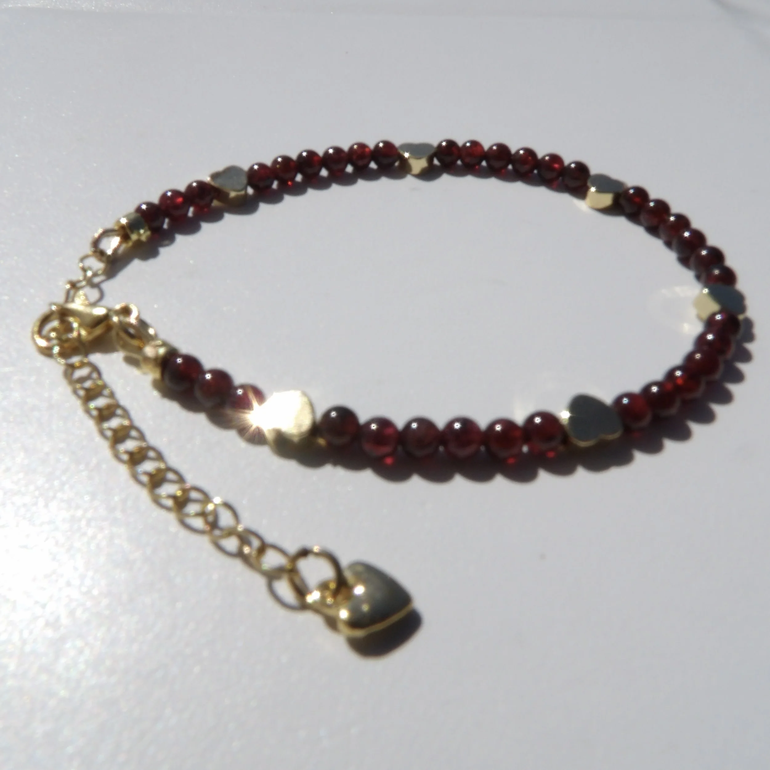 Elegant Garnet & Gold Heart Bracelet