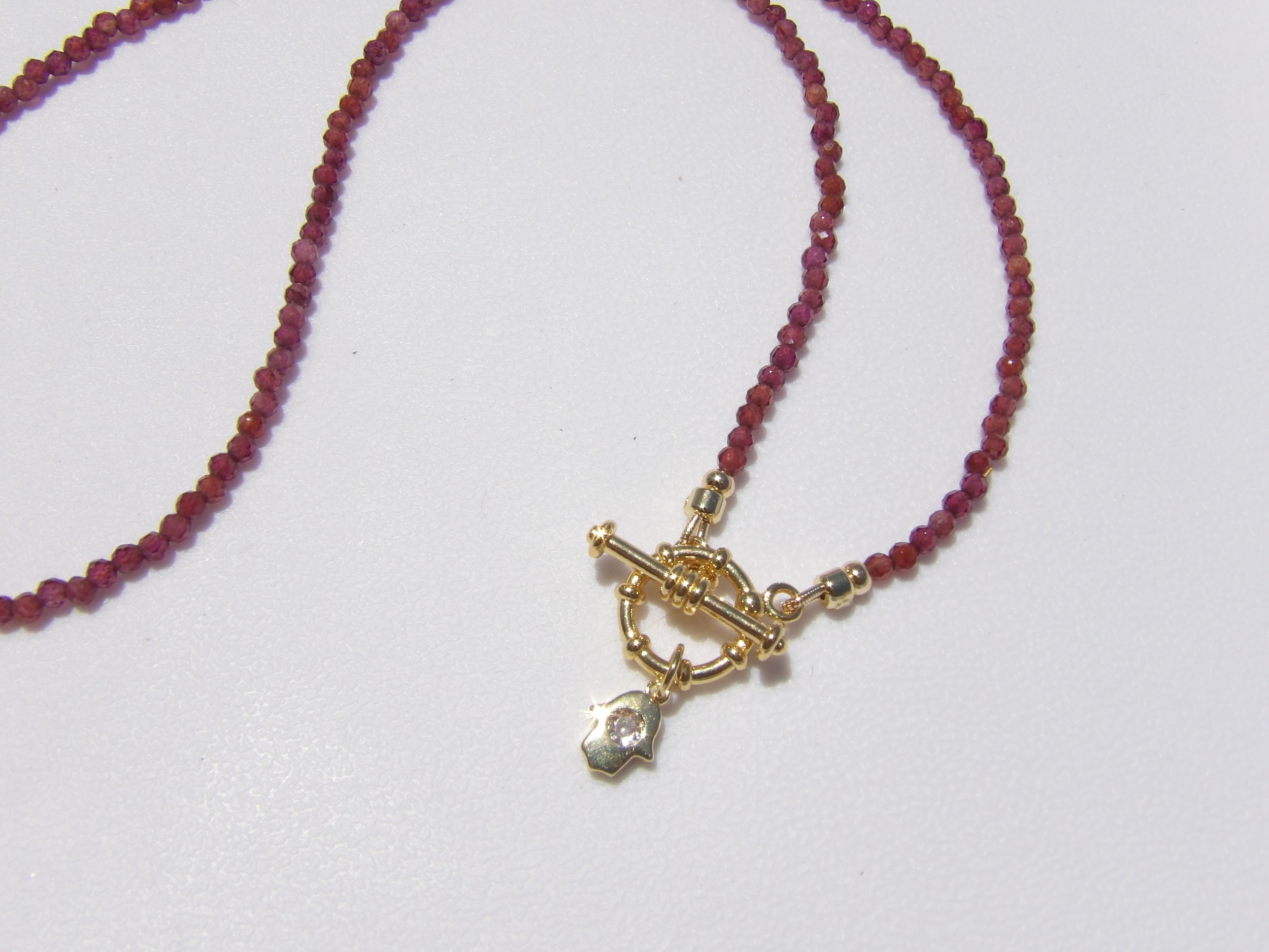 Faceted Garnet Hamsa Necklace with 18k Gold Plated Accents