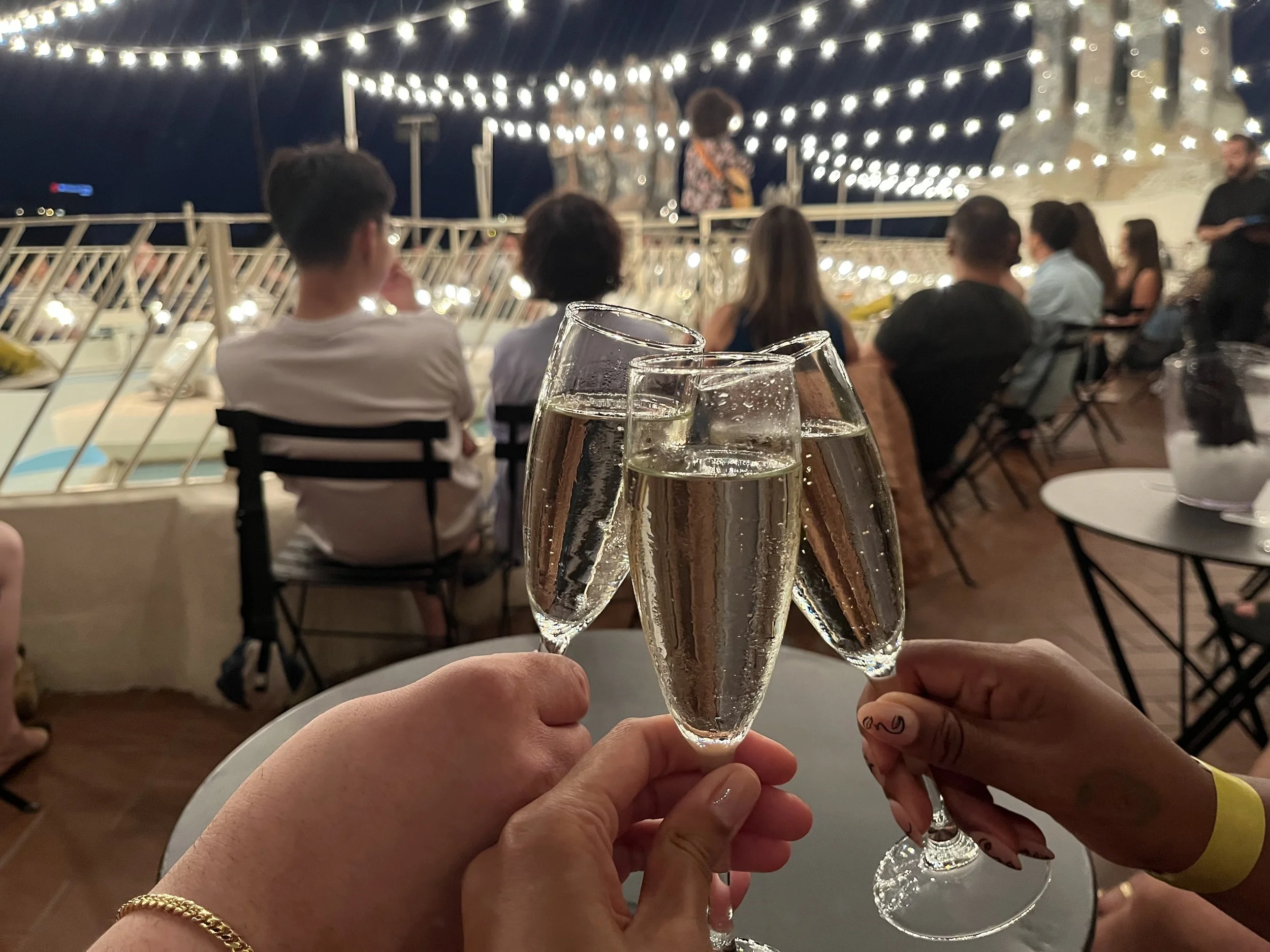 Cheers, 3 champagne glasses on rooftop in SPAIN at Casa Batlló