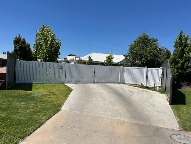 A beautiful white metal gate manufactured and installed by Nuggets