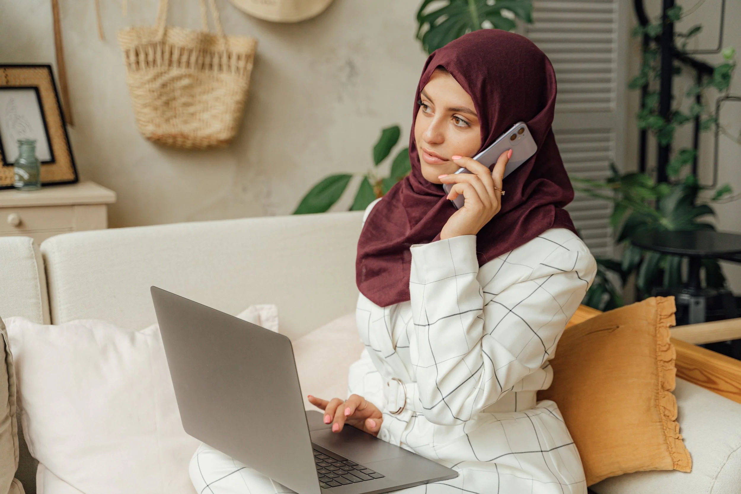 A Muslim student on a call with parents, expression strained