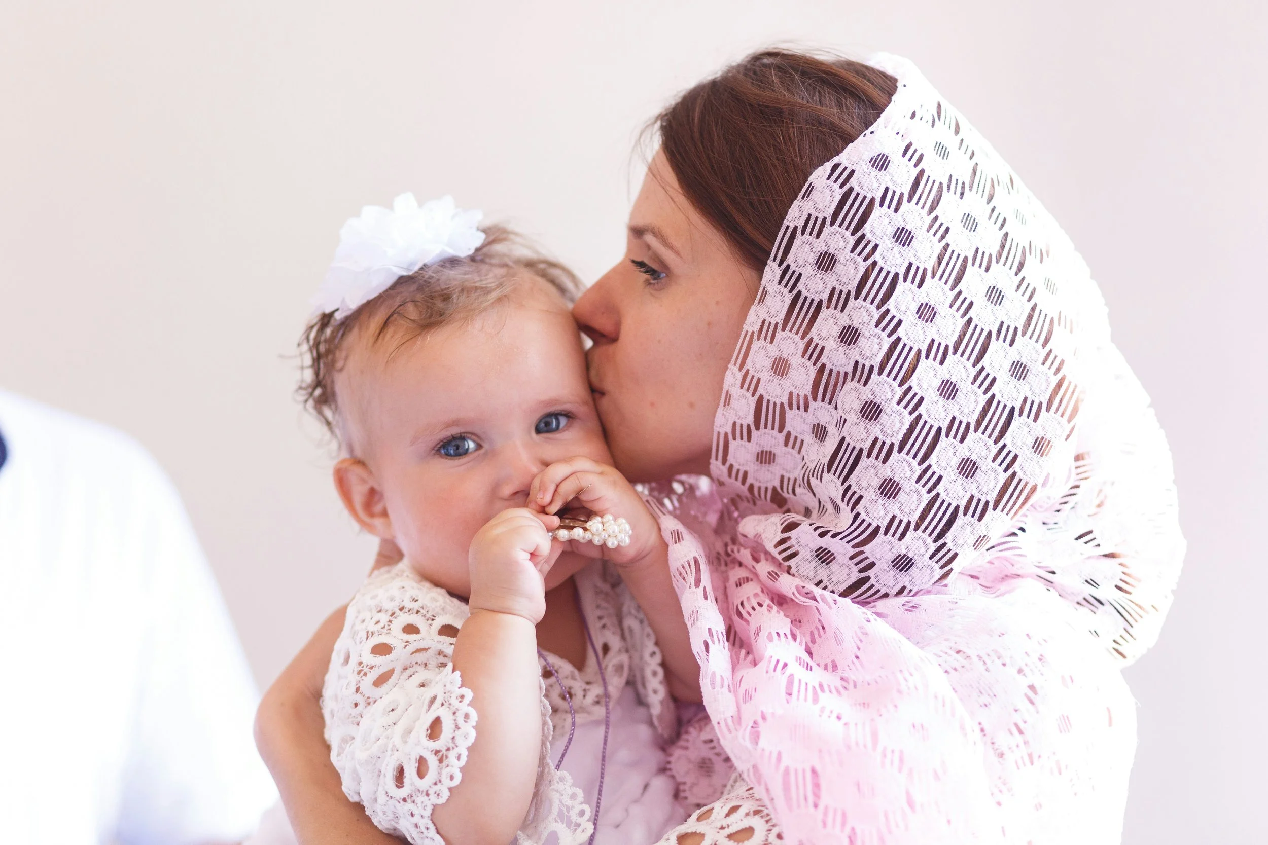A Muslim mother sitting with her newborn, looking tired