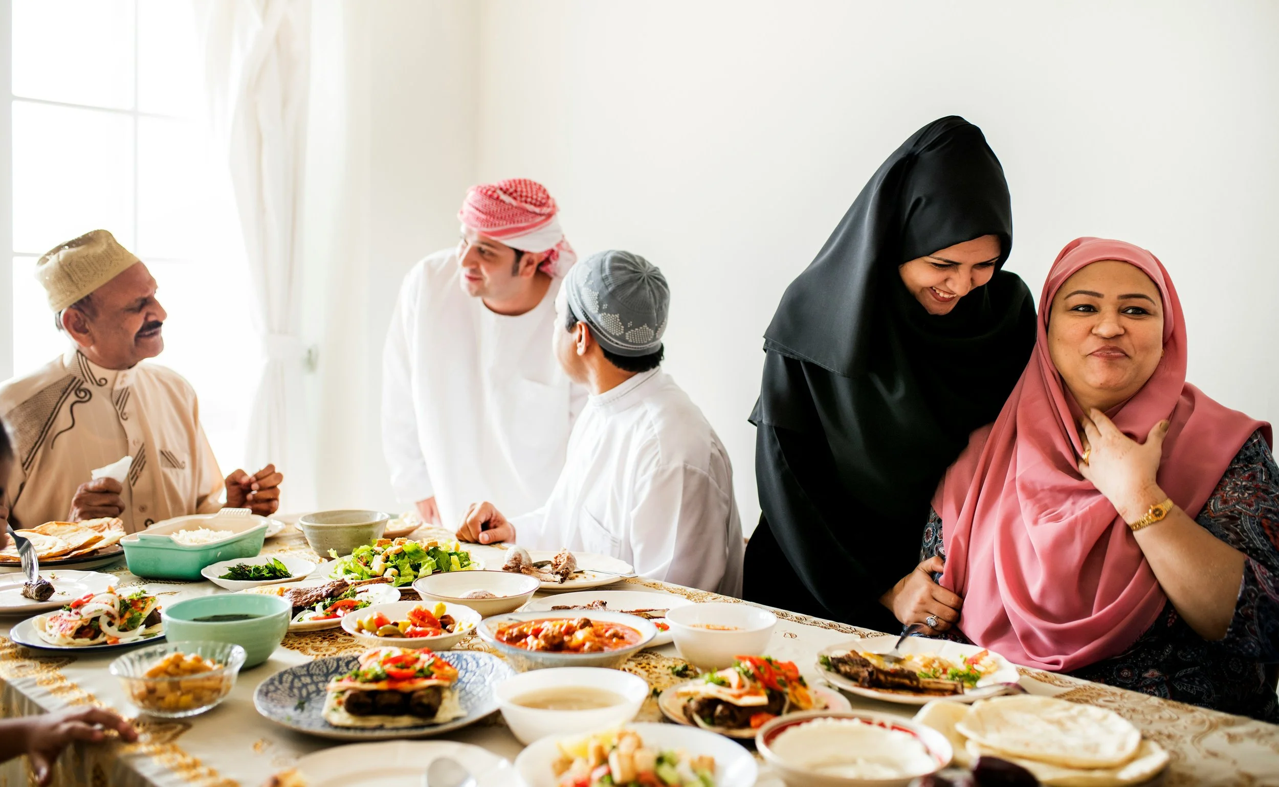 A family dinner table scene with lots of food