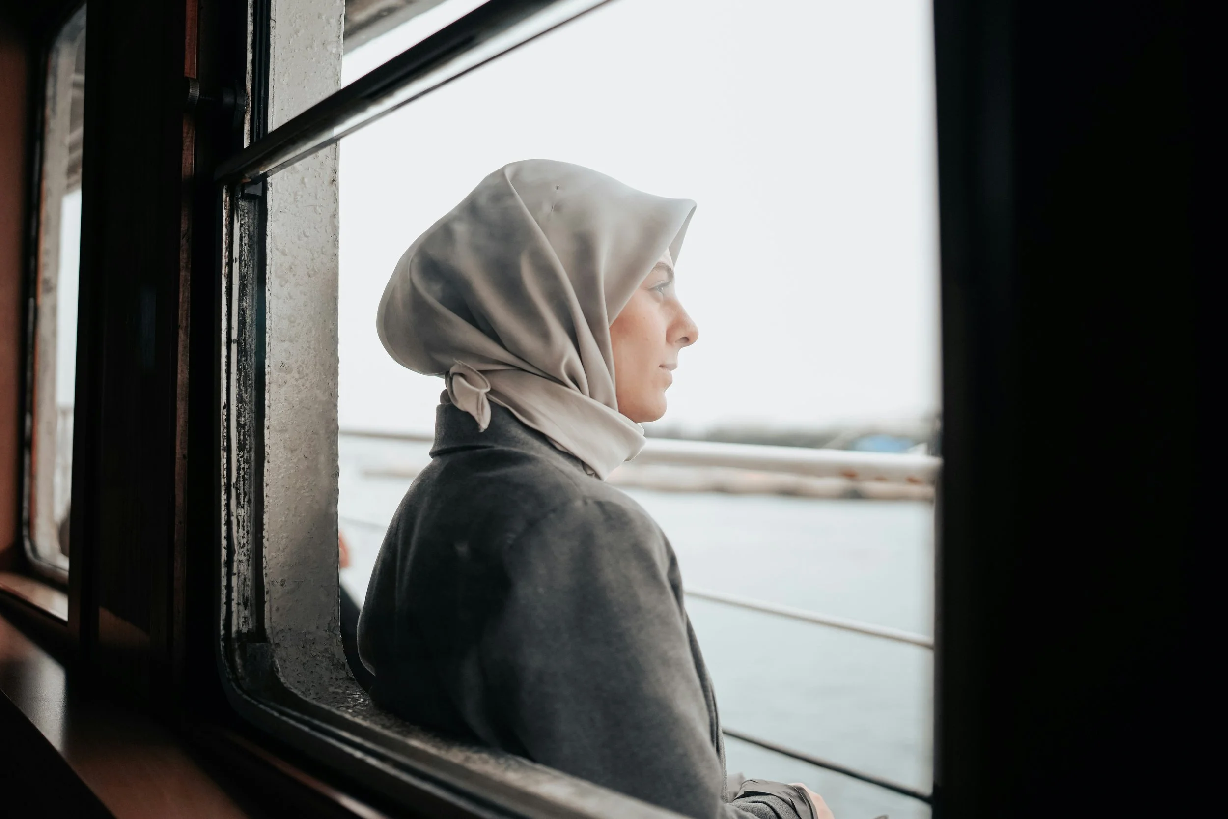 A Muslim woman in hijab looking thoughtful
