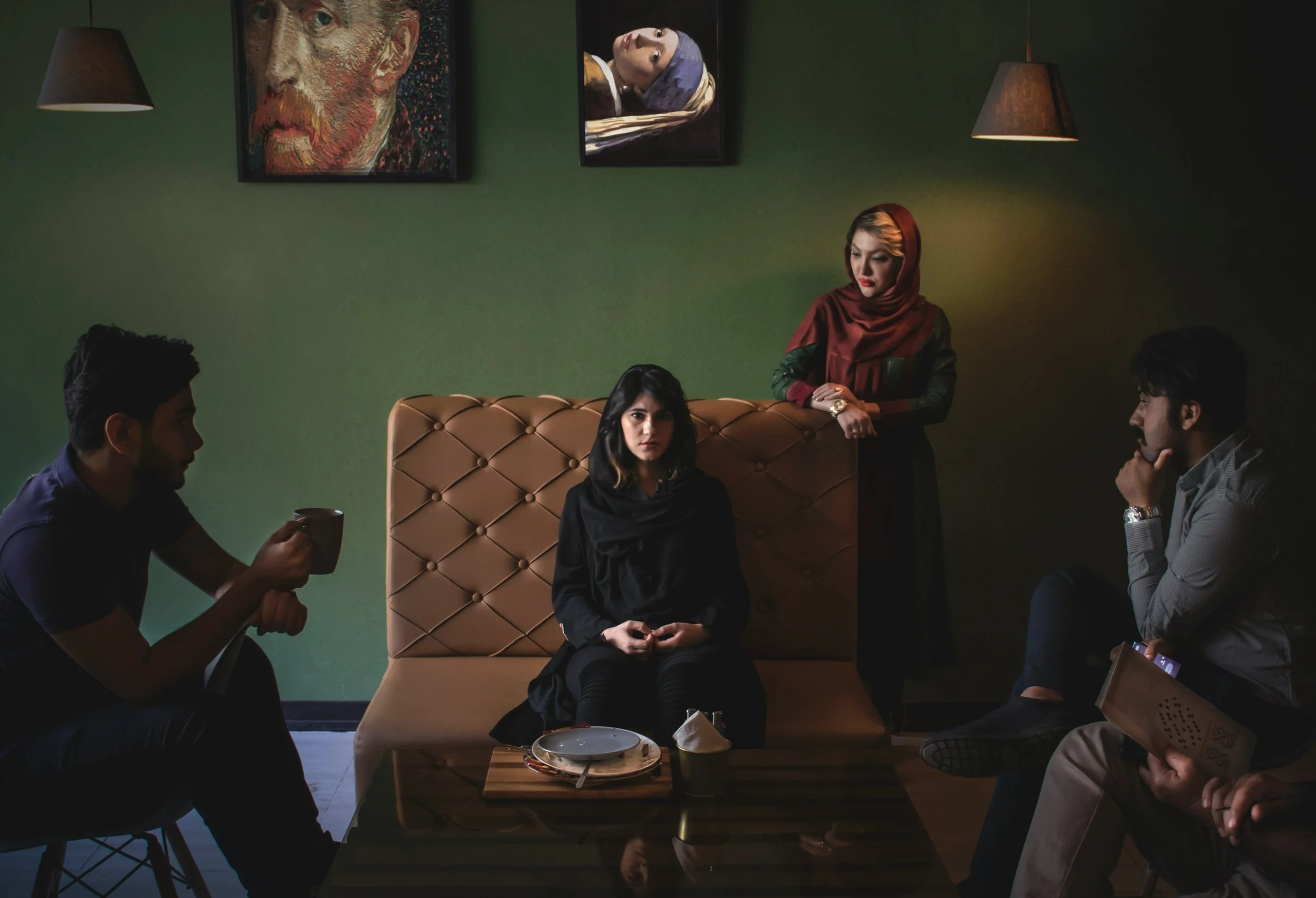 woman sitting distance from her family, looking nervous