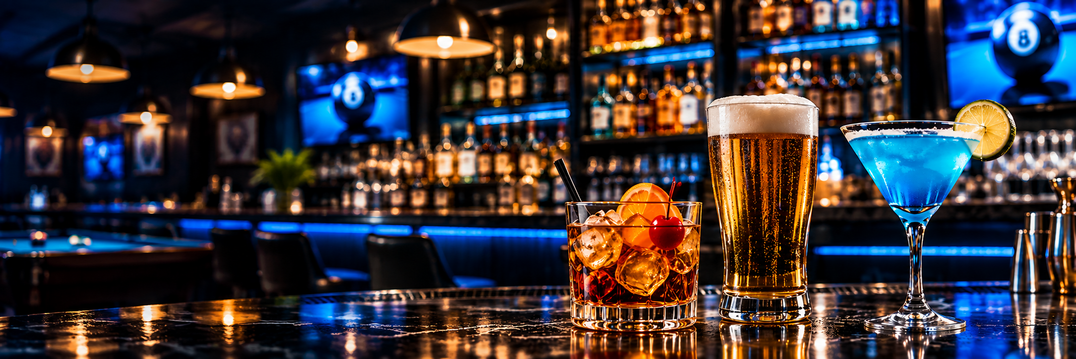 A cocktail, a draft beer and a blue martini on the bar