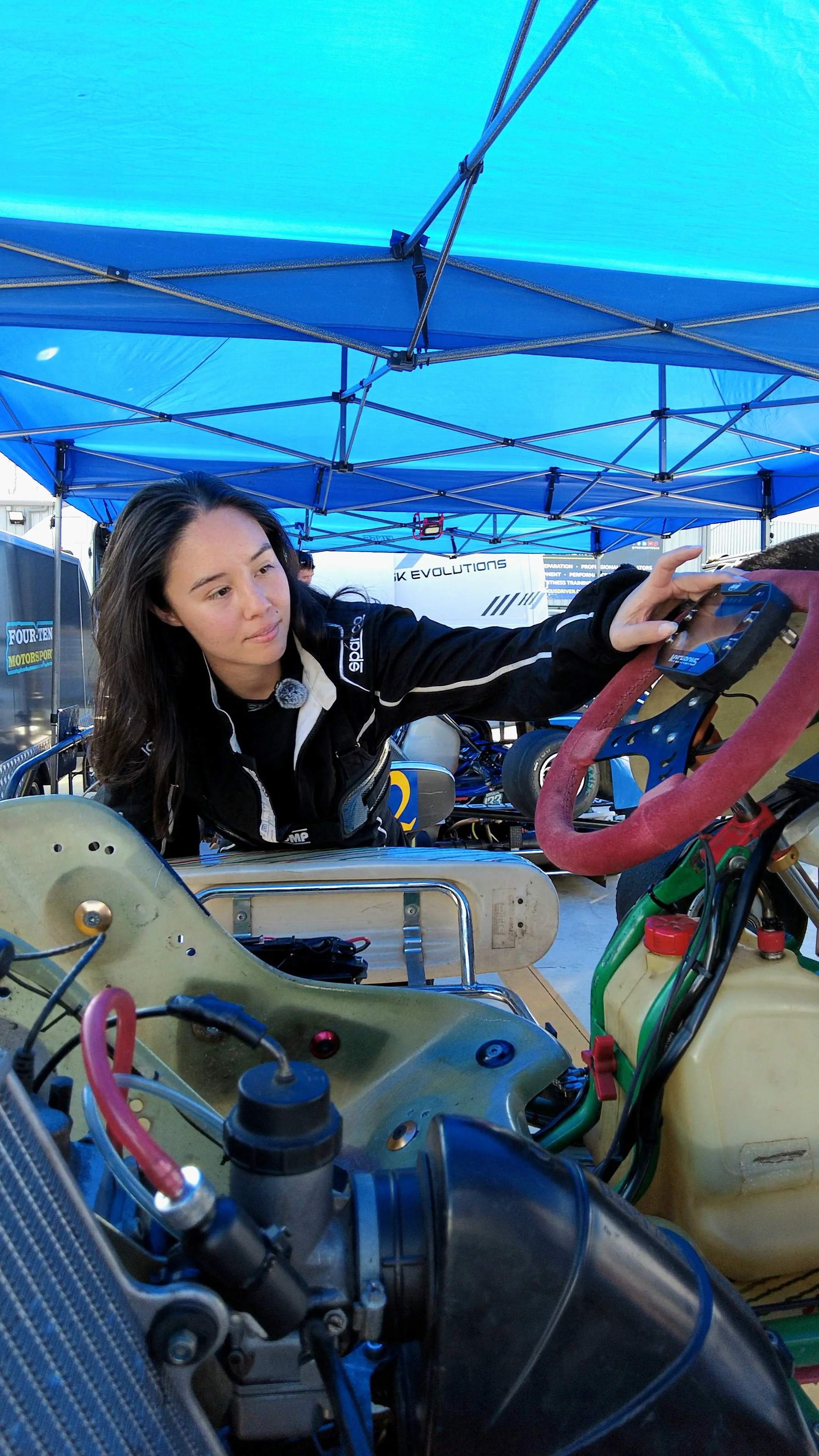 X LE pulling onboard data from her # 88 Superkart in the pits after a race.