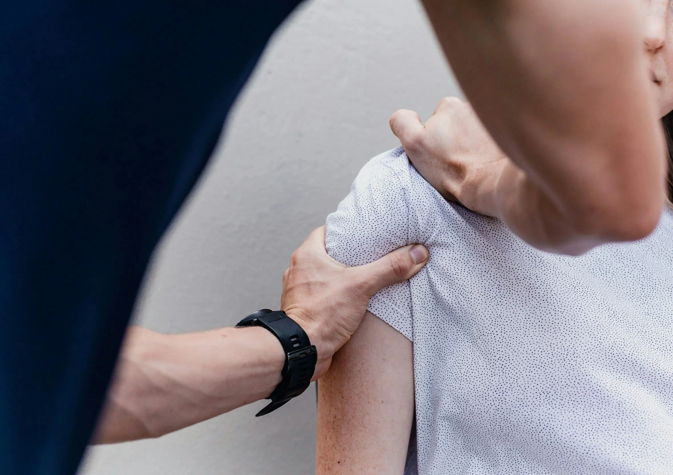 Chiropractor assessing patient’s shoulder joint for postural strain and mobility issues at Chiro Health Vision in Pymble