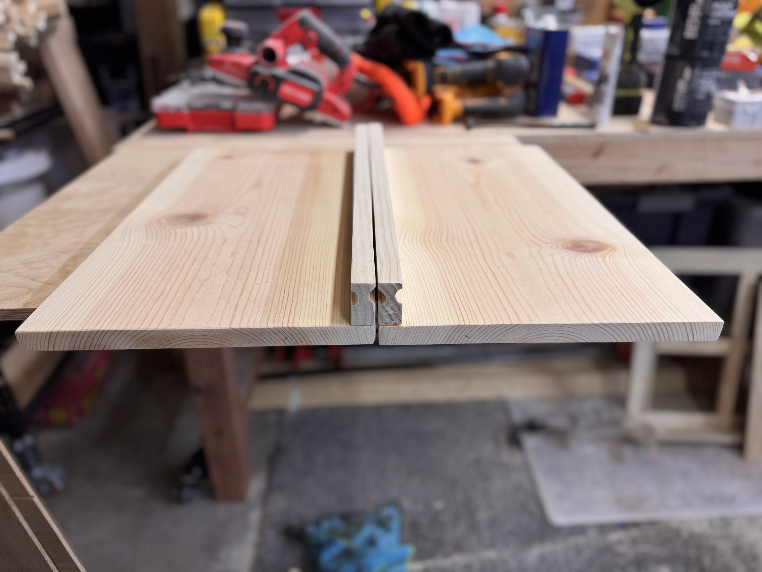 Custom handmade wood cabinet doors with routed edge detail, unfinished pine laundry room cubby doors in workshop