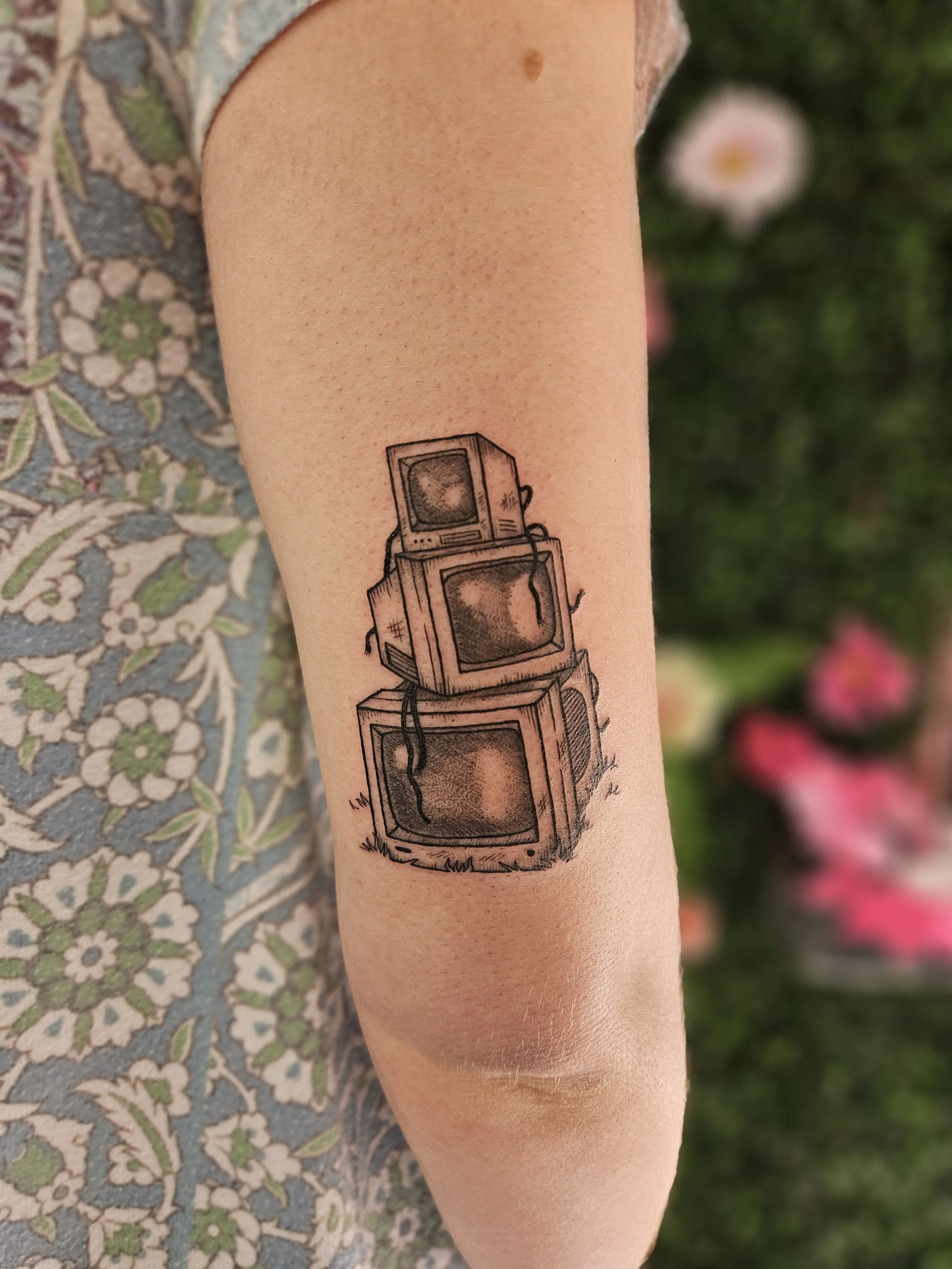 Tattoo inspired by SZA's CTRL album, showing three stacked vintage monitors on a person's arm.