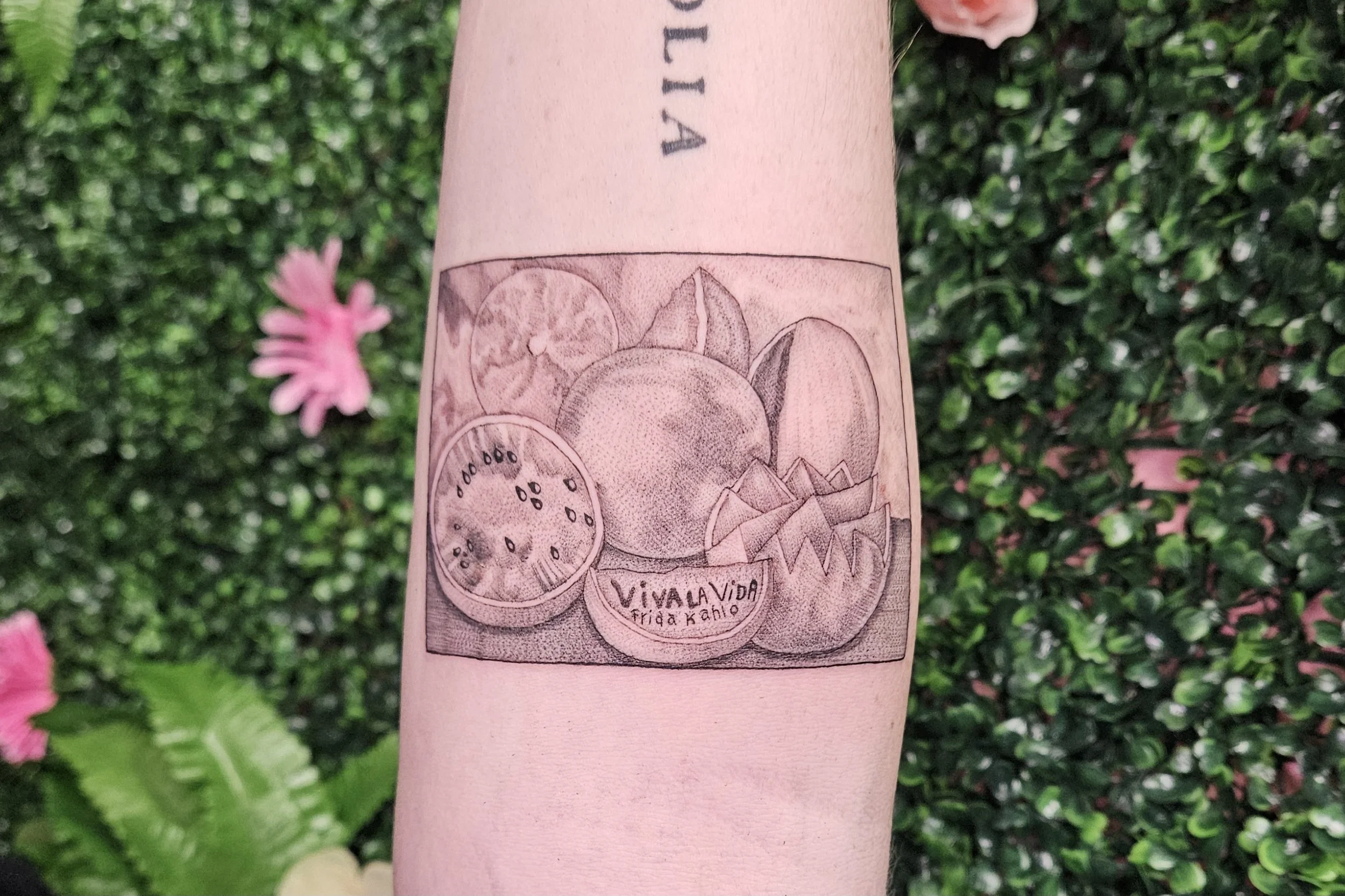 Tattoo rendition of Frida Kahlo's "Viva la Vida" painting showing various cuts of watermelon and the text "Viva la Vida" and "Frida Kahlo" below the fruits.