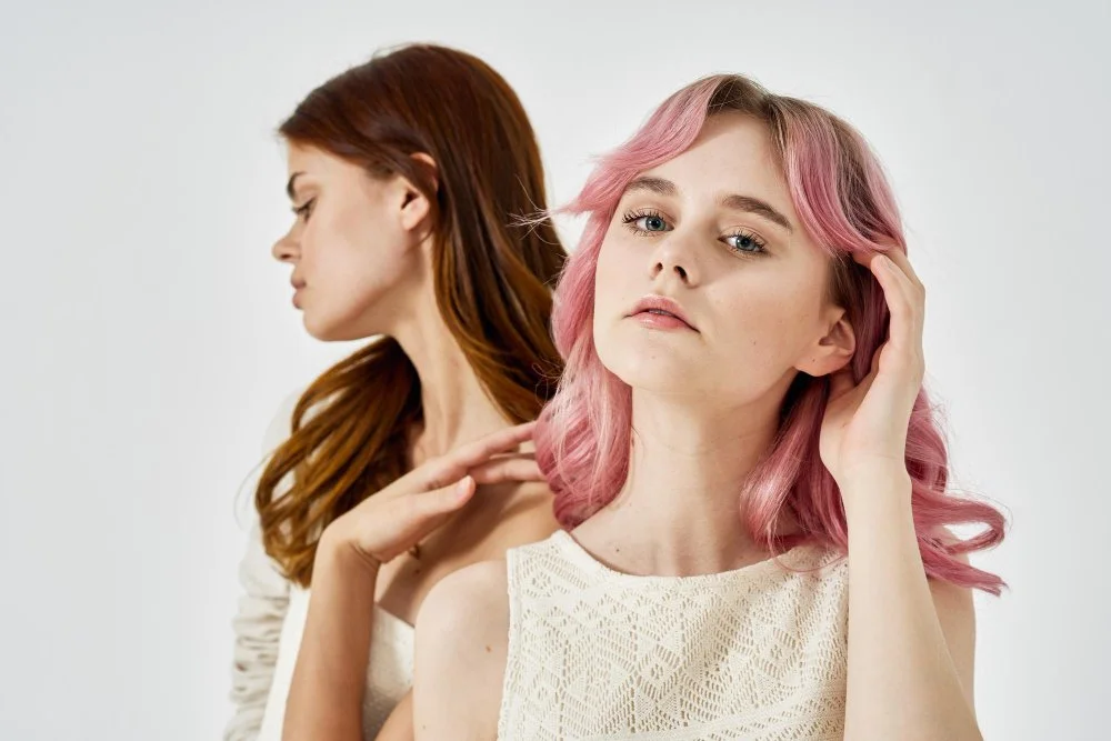 Salon client reviewing swatches to choose from the top hair color options with a professional stylist.