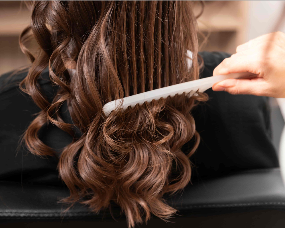 Curling wand shapes bouncy waves through rich brunette hair