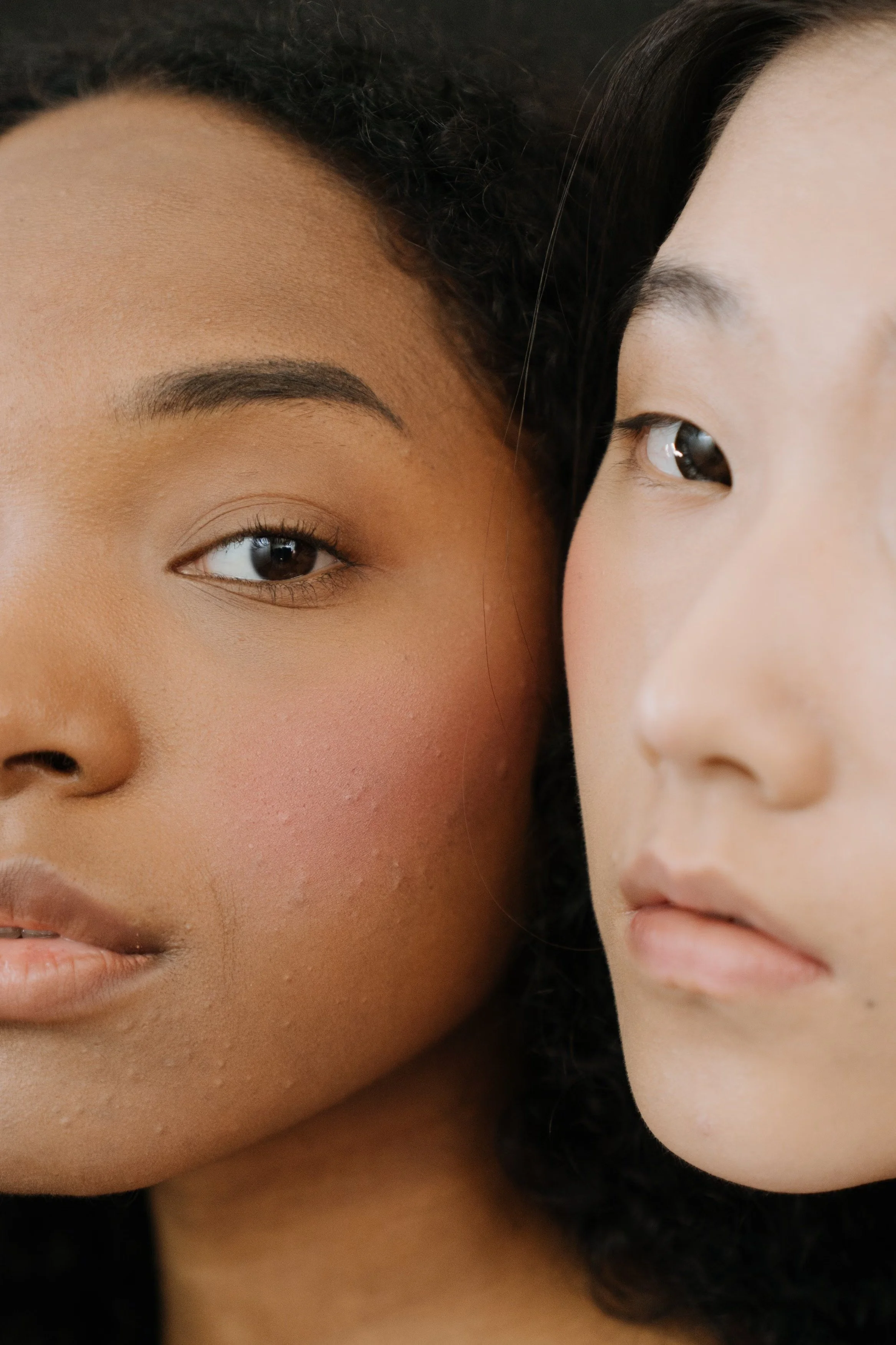 Close-up of a skincare consultation between an esthetician and a teenage client.