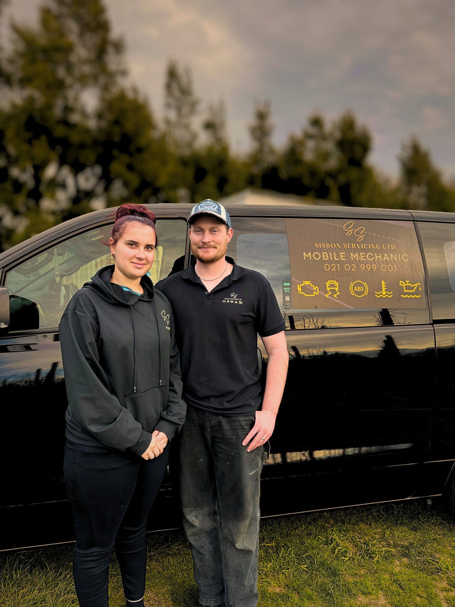 Porsha and Connor Sisson of Sisson Servicing Limited standing with their mobile mechanic service van in Napier, Hawke's Bay.