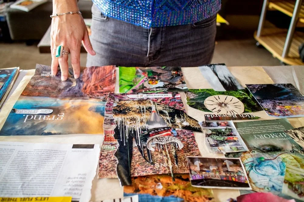Person looking at a table with various colorful magazine pages and photographs, some of which depict nature scenes, workplaces, and art.