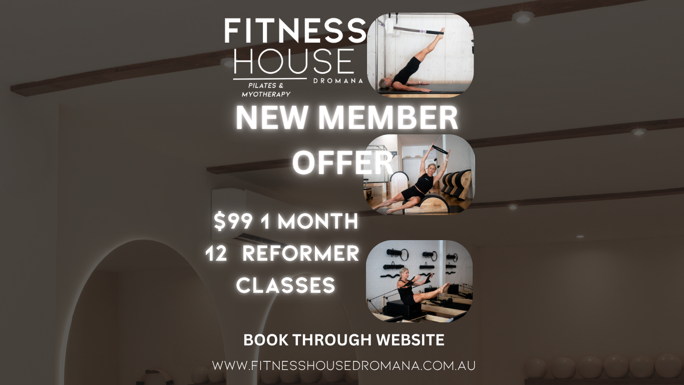 A woman with curly hair doing Pilates on a reformer machine in a bright, modern gym with plants.