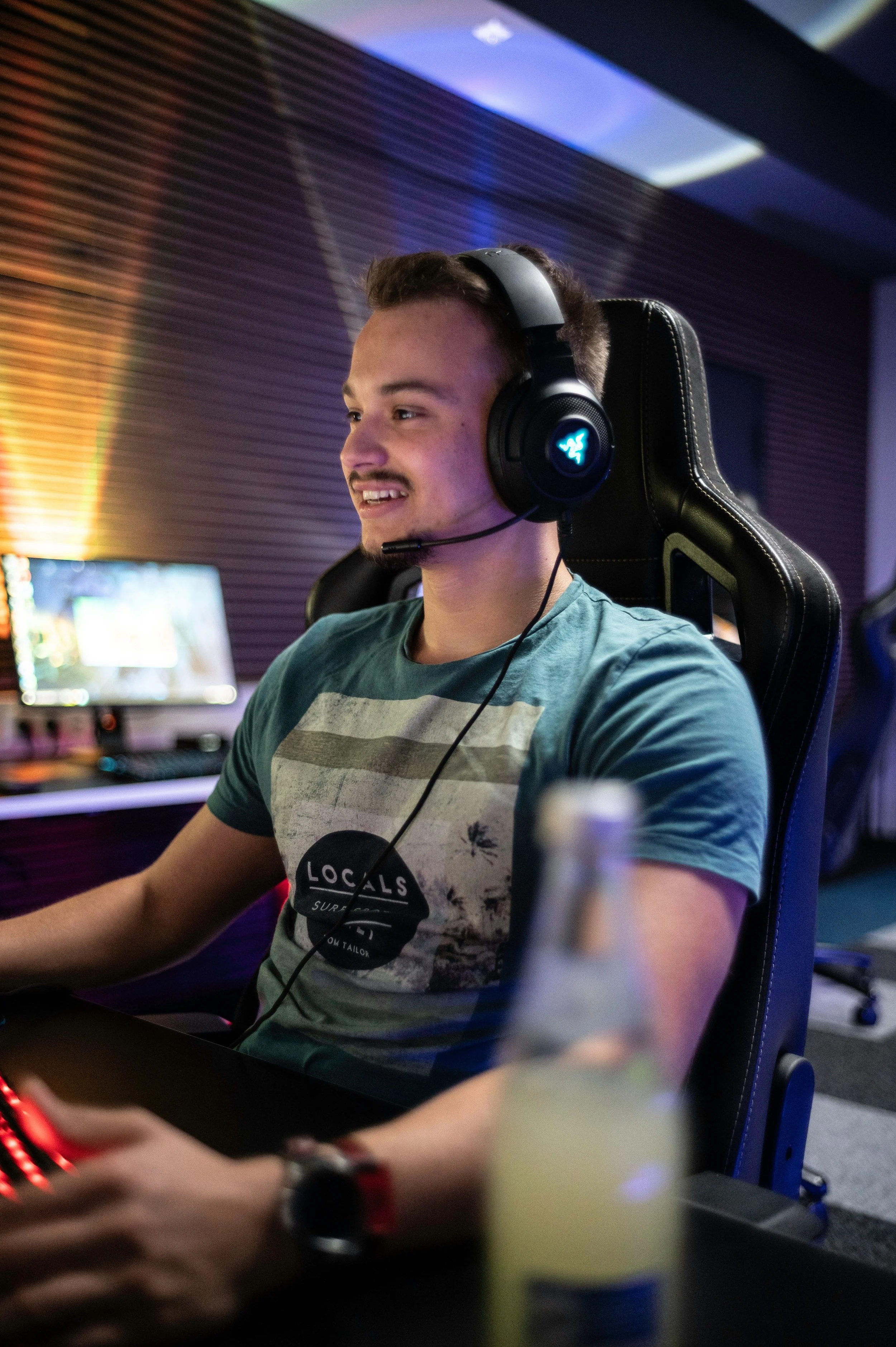 Young man wearing gaming headset using a computer.