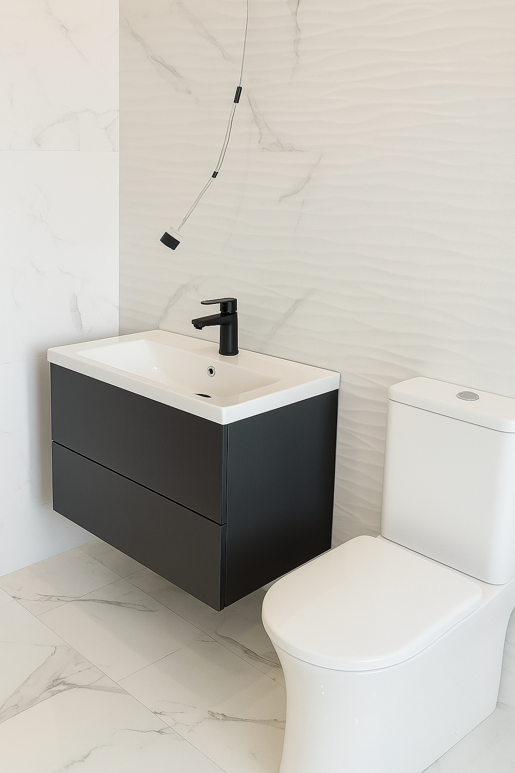Modern bathroom with a white toilet, a black vanity with a white sink, and a black faucet, featuring a textured light wall and marble floor tiles.