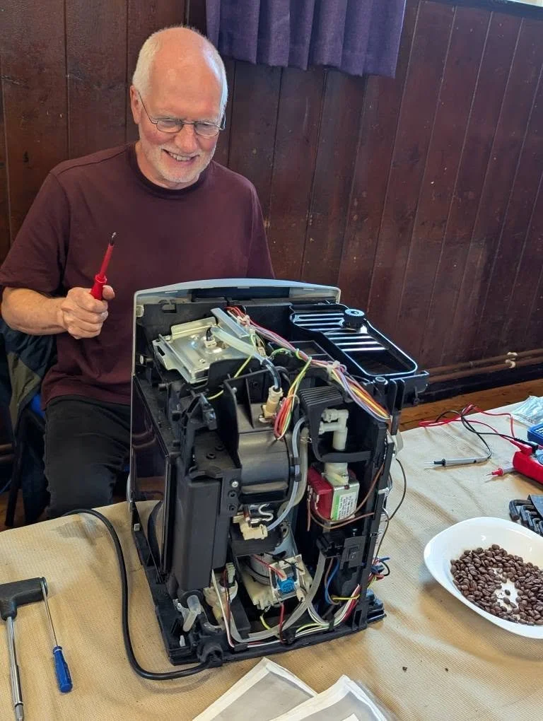 Den repairing a coffee machine