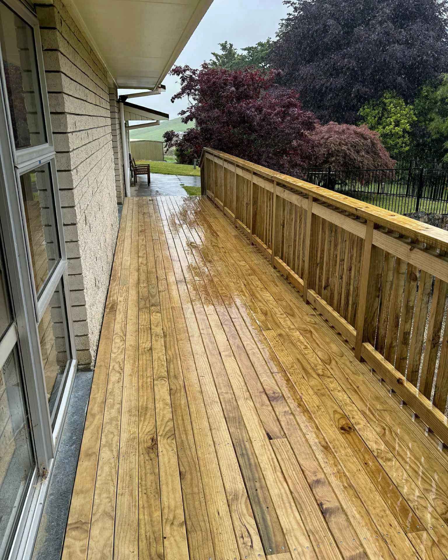 large timber deck with handrail