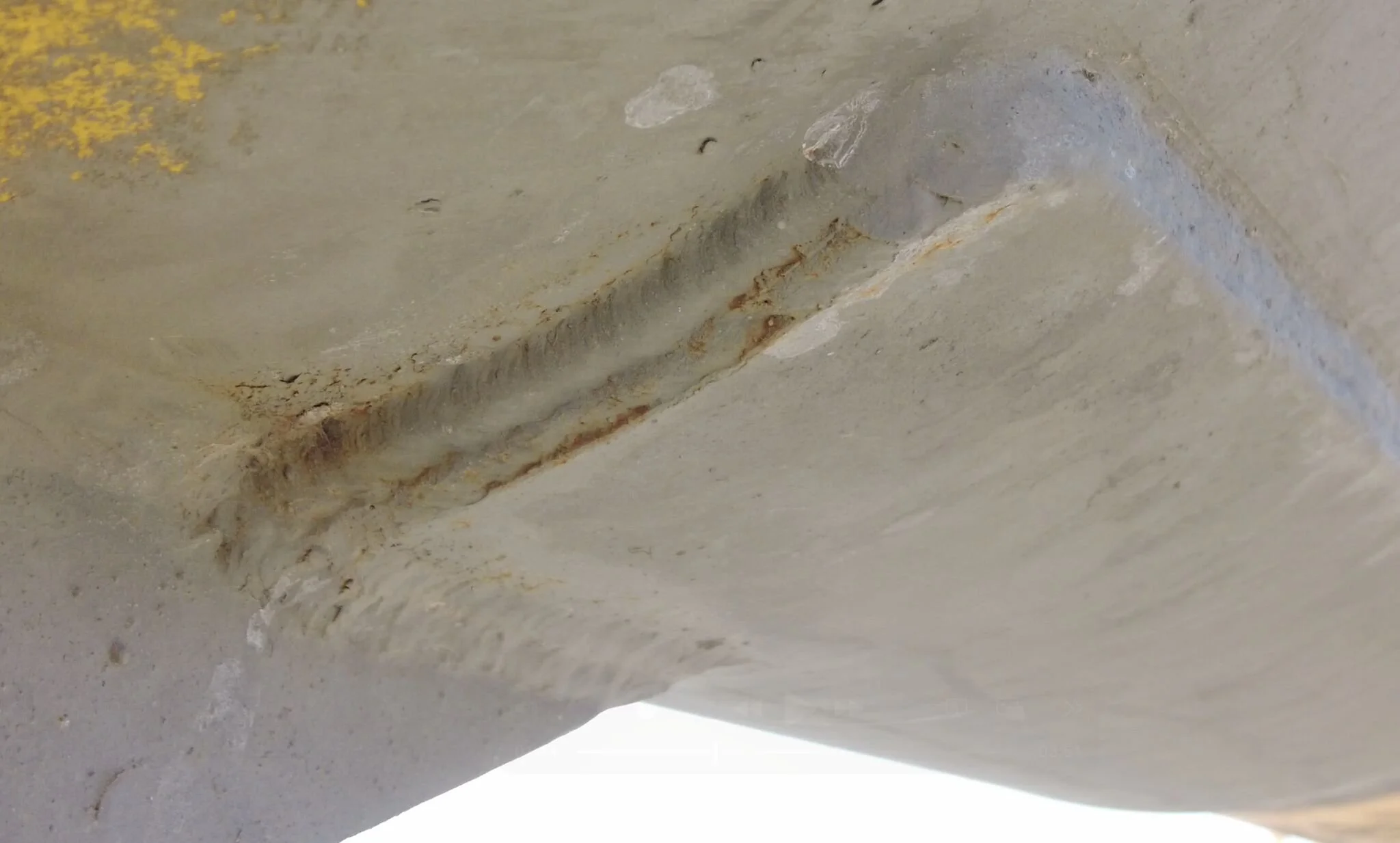 Close-up of a rusty metal bolt and metal surface with signs of corrosion and rust.