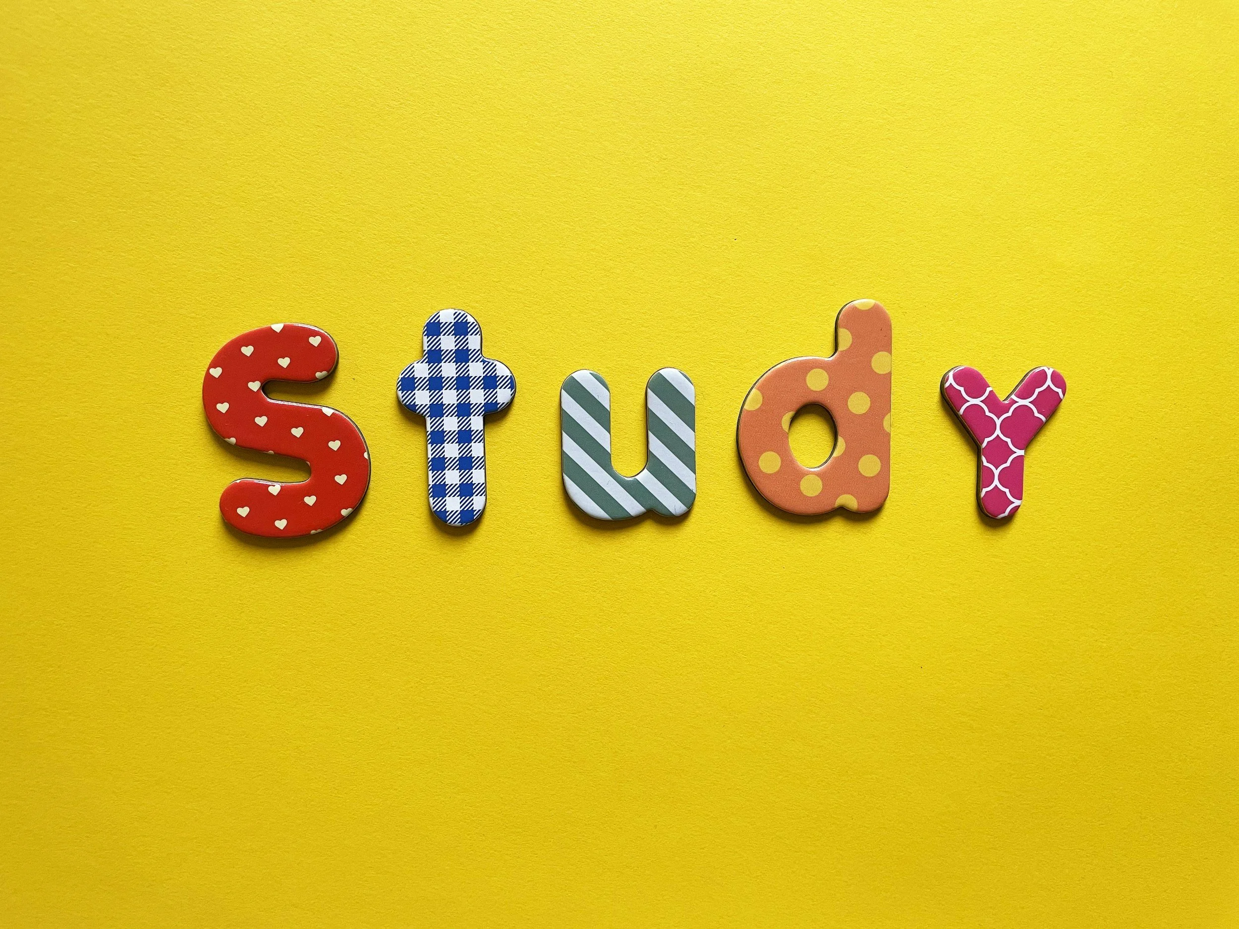 Colorful letters spelling 'study' on a yellow background