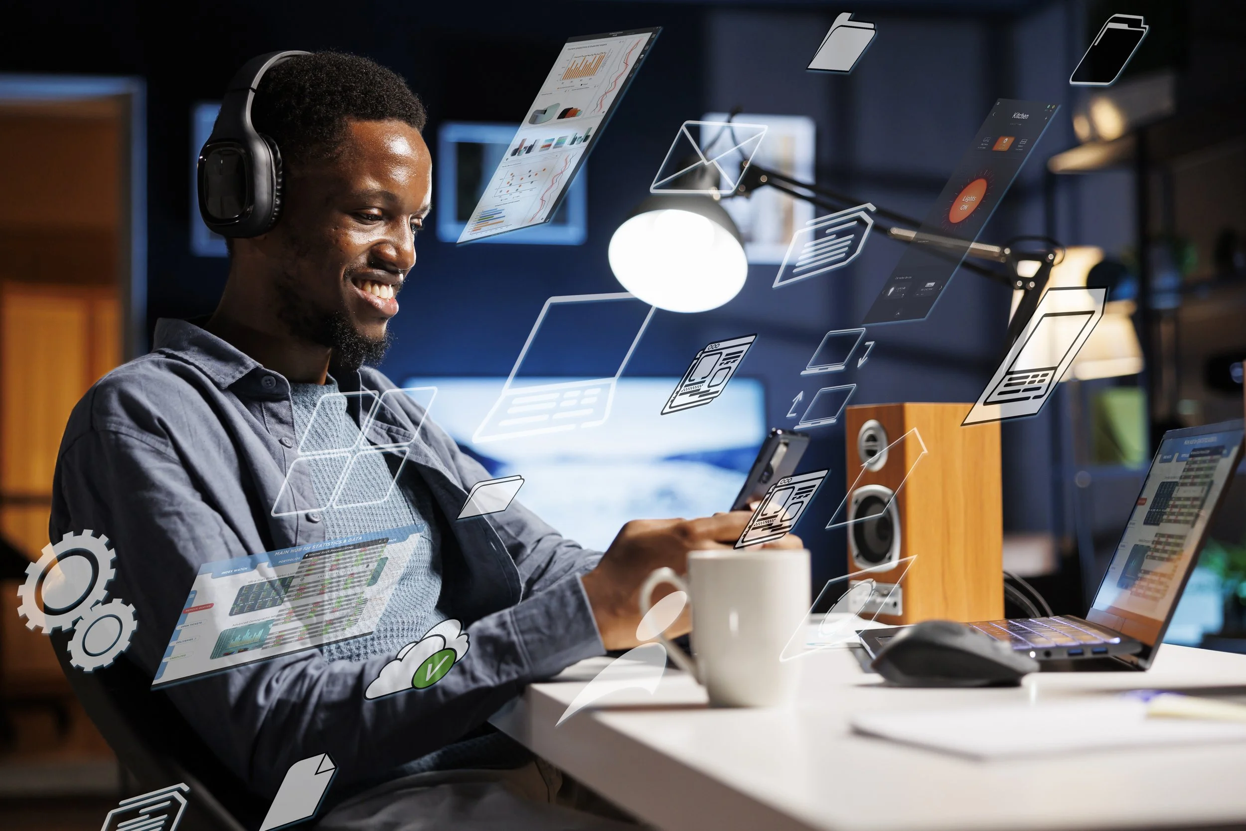 A man with headphones smiling while using a smartphone at a workspace, surrounded by digital app icons and data overlays.