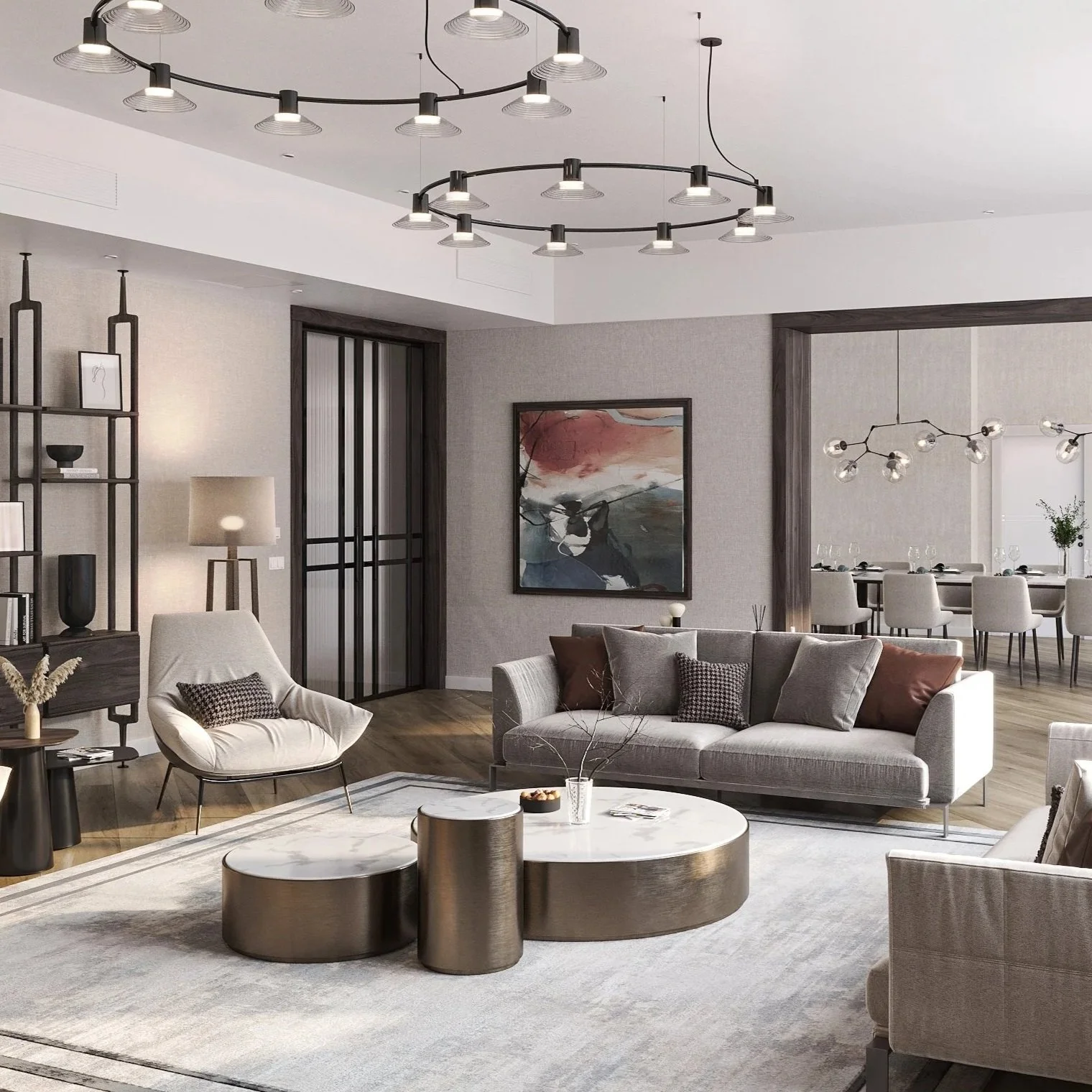Modern living room with light gray sofa, abstract art on the wall, beige armchairs, wooden and metallic coffee tables, a gray rug, and contemporary lighting fixtures.